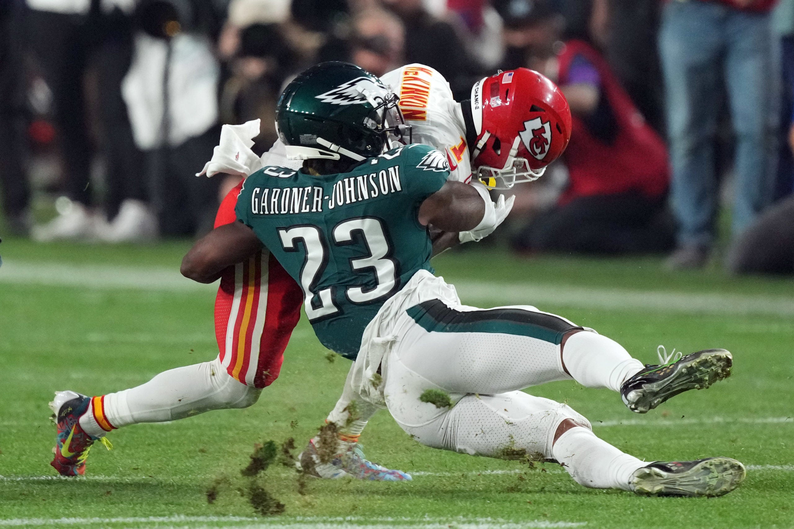 Glendale, Arizona, US; Philadelphia Eagles safety C.J. Gardner-Johnson (23) tackles Kansas City Chiefs running back Jerick McKinnon (1) in the third quarter of Super Bowl LVII at State Farm Stadium.