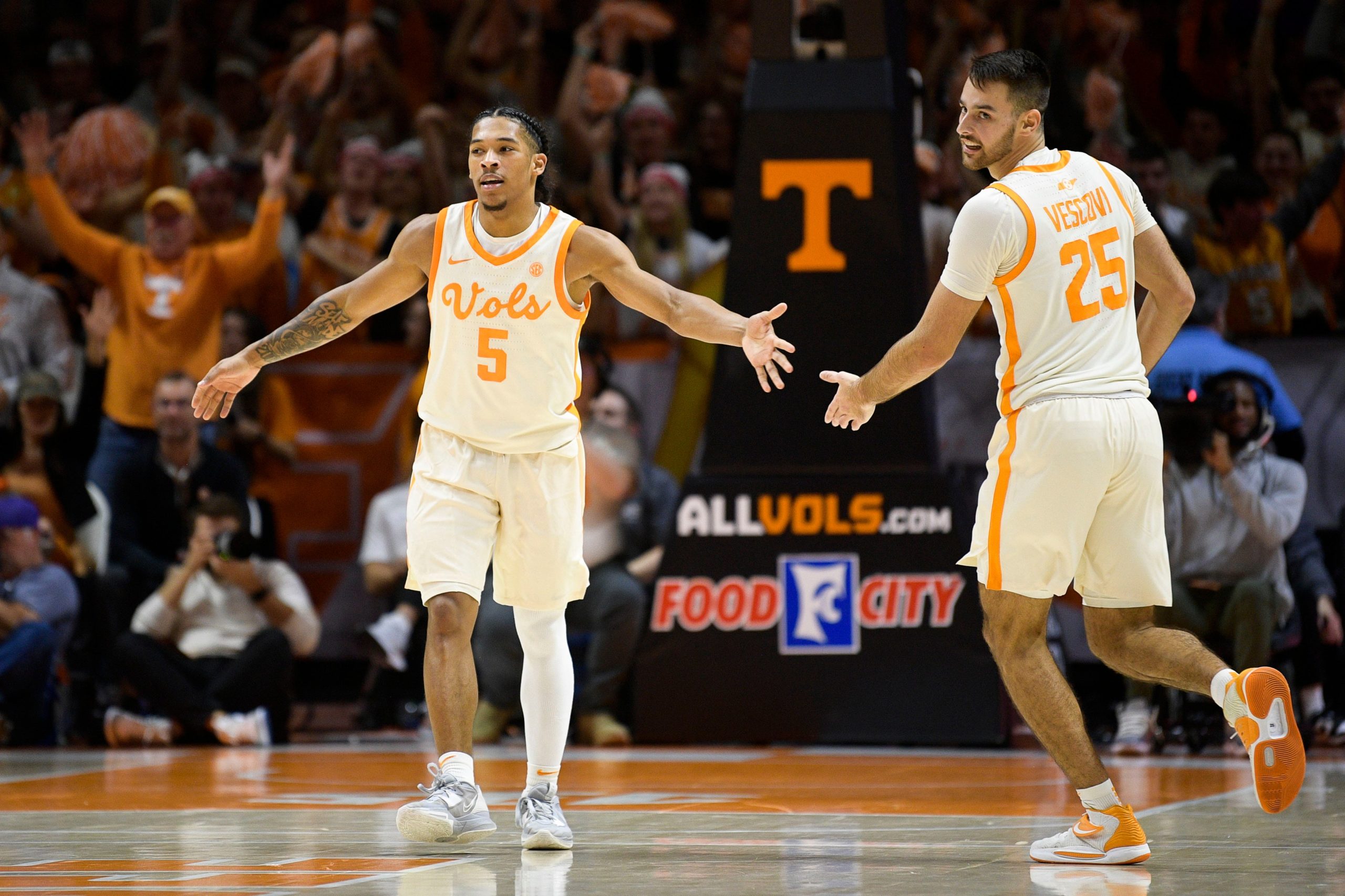 Tennessee guard Zakai Zeigler (5) congratulates Tennessee guard Santiago Vescovi (25) on a play during a game between Tennessee and Texas at Thompson-Boling Arena in Knoxville, Tenn., on Saturday, Jan. 28, 2023. Kns Ut Basketball Vs Texas