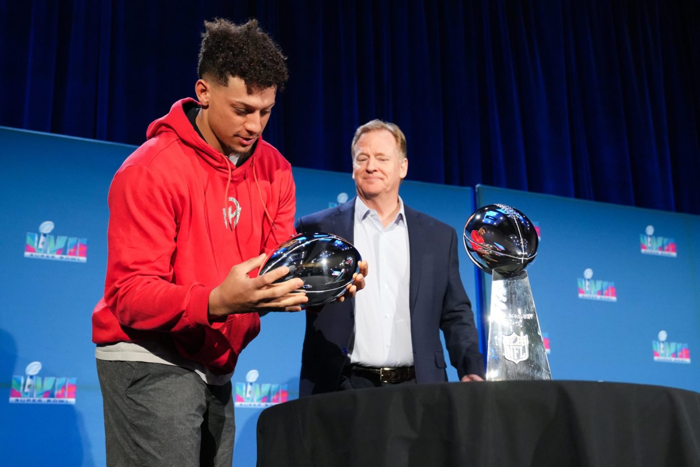 Chiefs QB Patrick Mahomes picks up the Super Bowl MVP trophy alongside NFL commissioner Roger Goodell during a news conference for the winning coach and MVP of Super Bowl 57. Syndication Arizona Republic