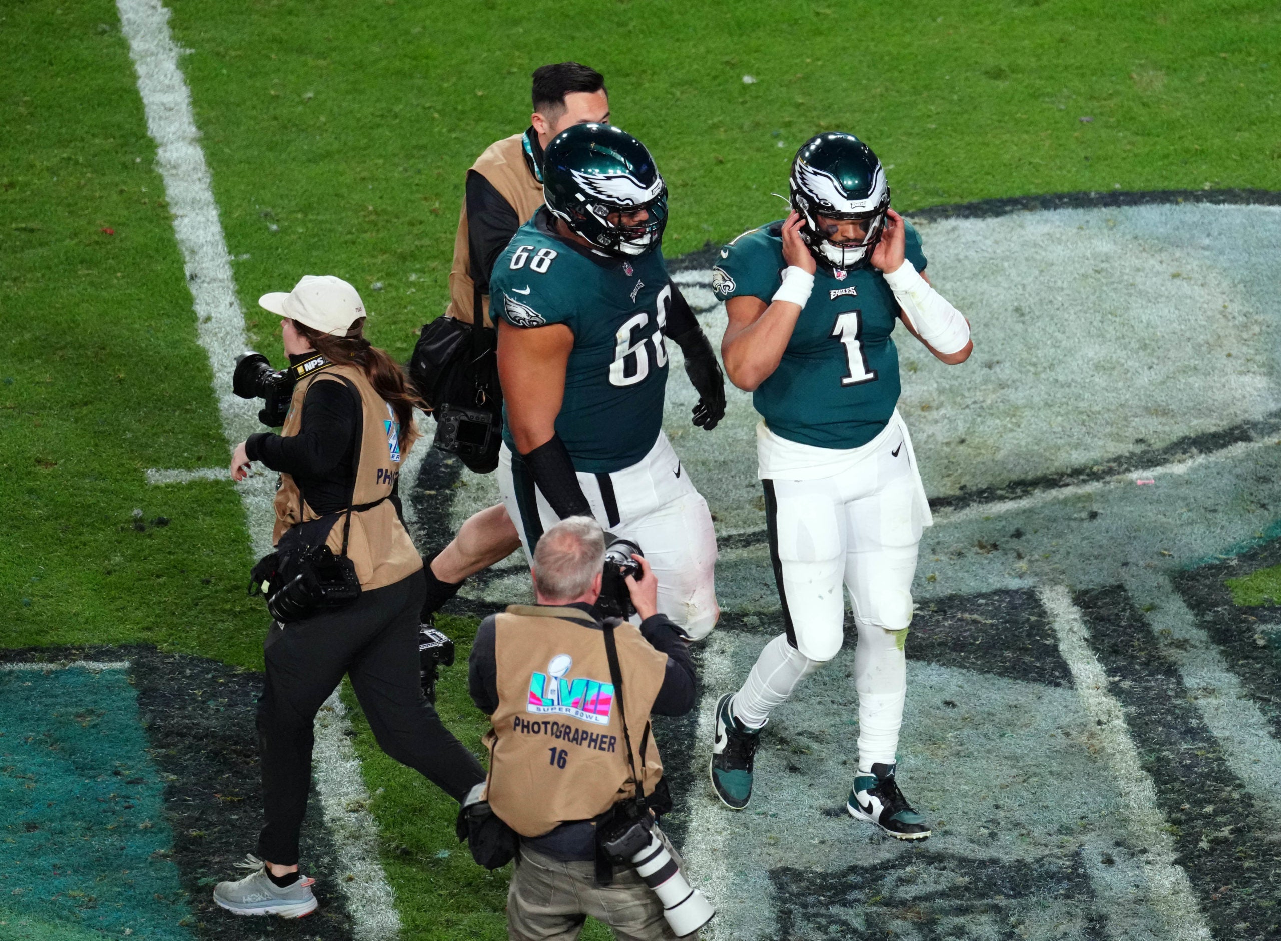 Philadelphia Eagles quarterback Jalen Hurts (1) and offensive tackle Jordan Mailata (68) walk off the field after losing to the Kansas City Chiefs in Super Bowl LVII at State Farm Stadium.
