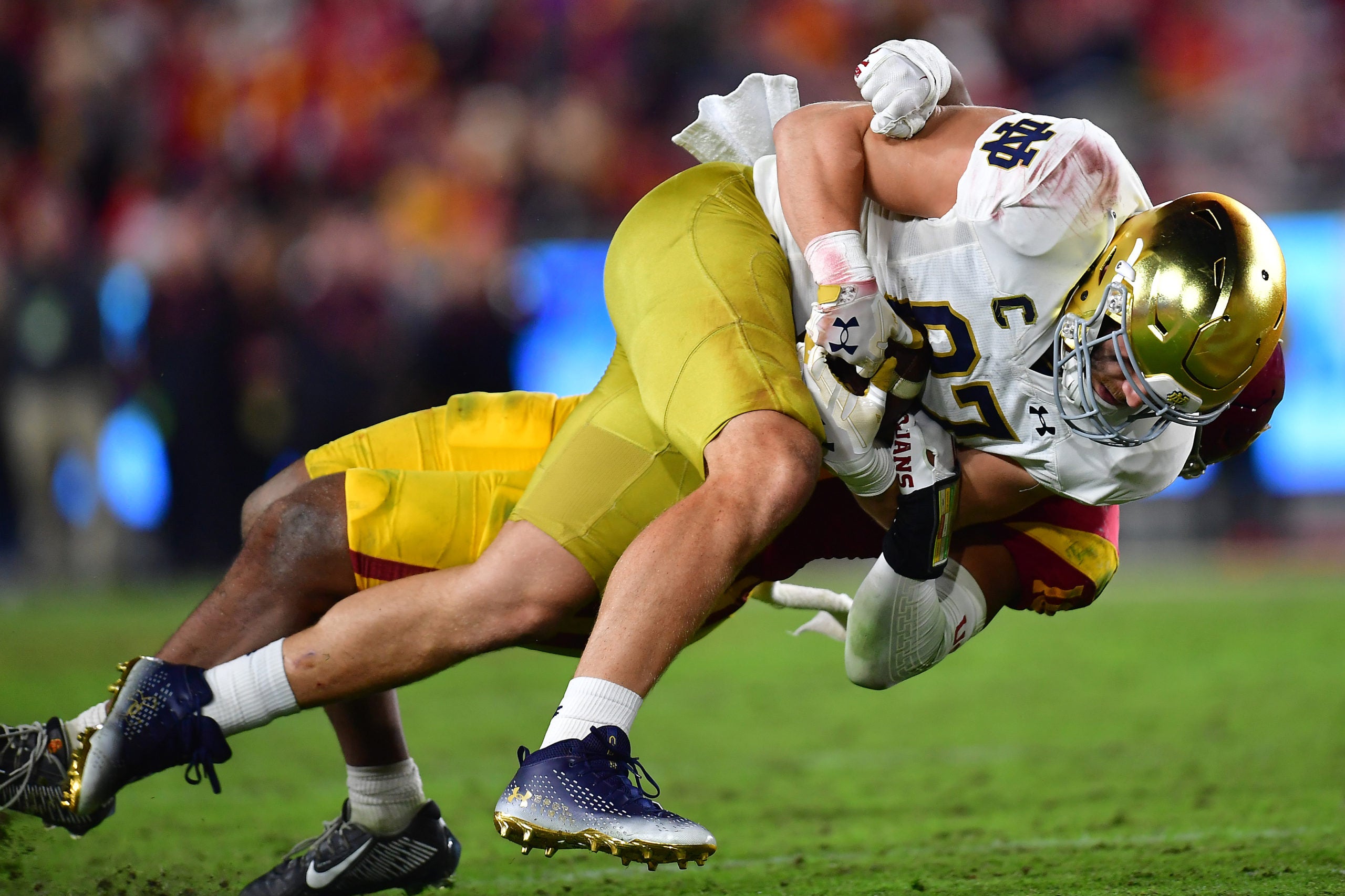 Nov 26, 2022; Los Angeles, California, USA; Notre Dame Fighting Irish tight end Michael Mayer (87) is brought down against the Southern California Trojans the second half at the Los Angeles Memorial Coliseum. Mandatory Credit: Gary A. Vasquez-USA TODAY Sports