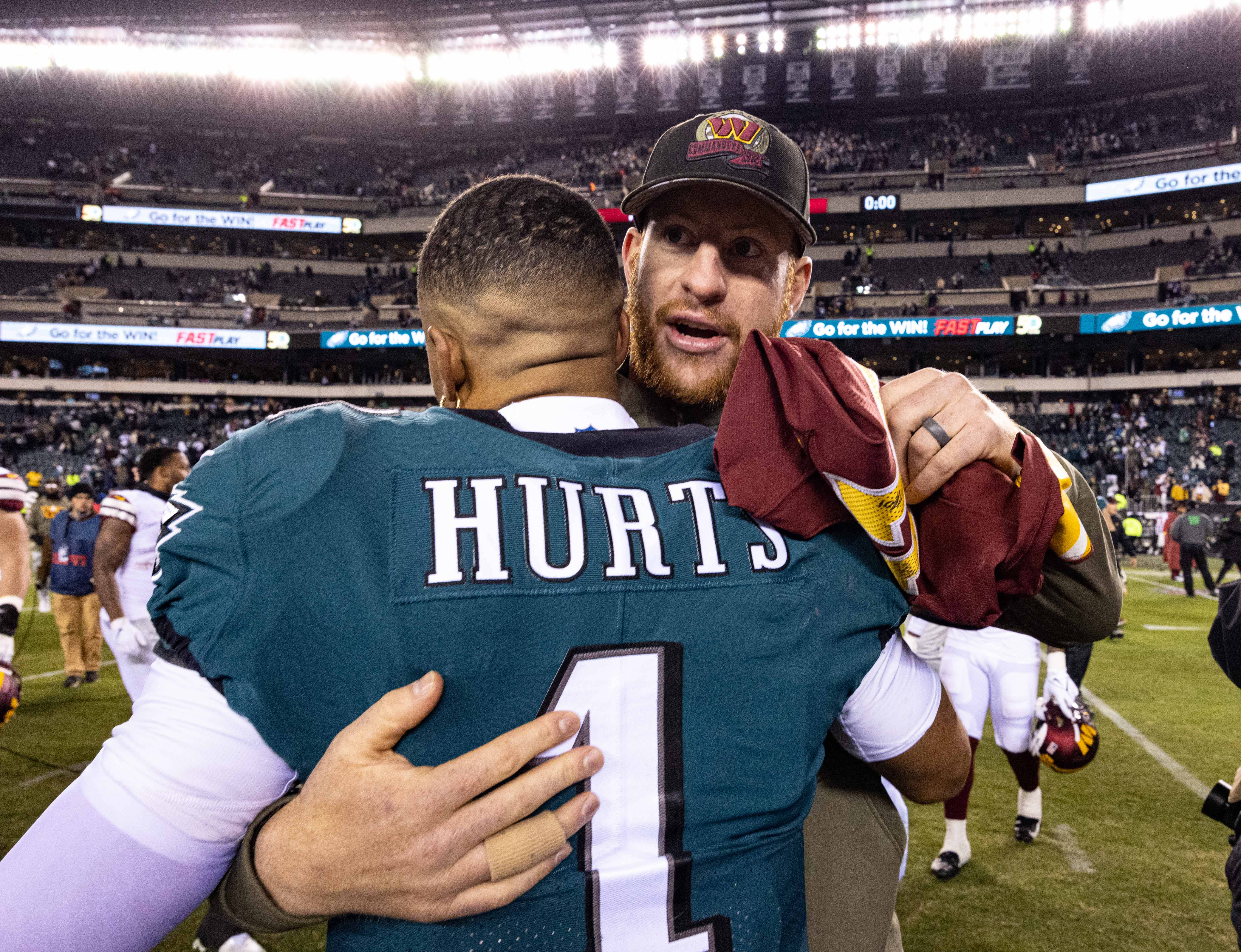 Philadelphia, Pennsylvania, USA; Philadelphia Eagles quarterback Jalen Hurts (1) hugs Washington Commanders injured quarterback Carson Wentz after the game at Lincoln Financial Field.