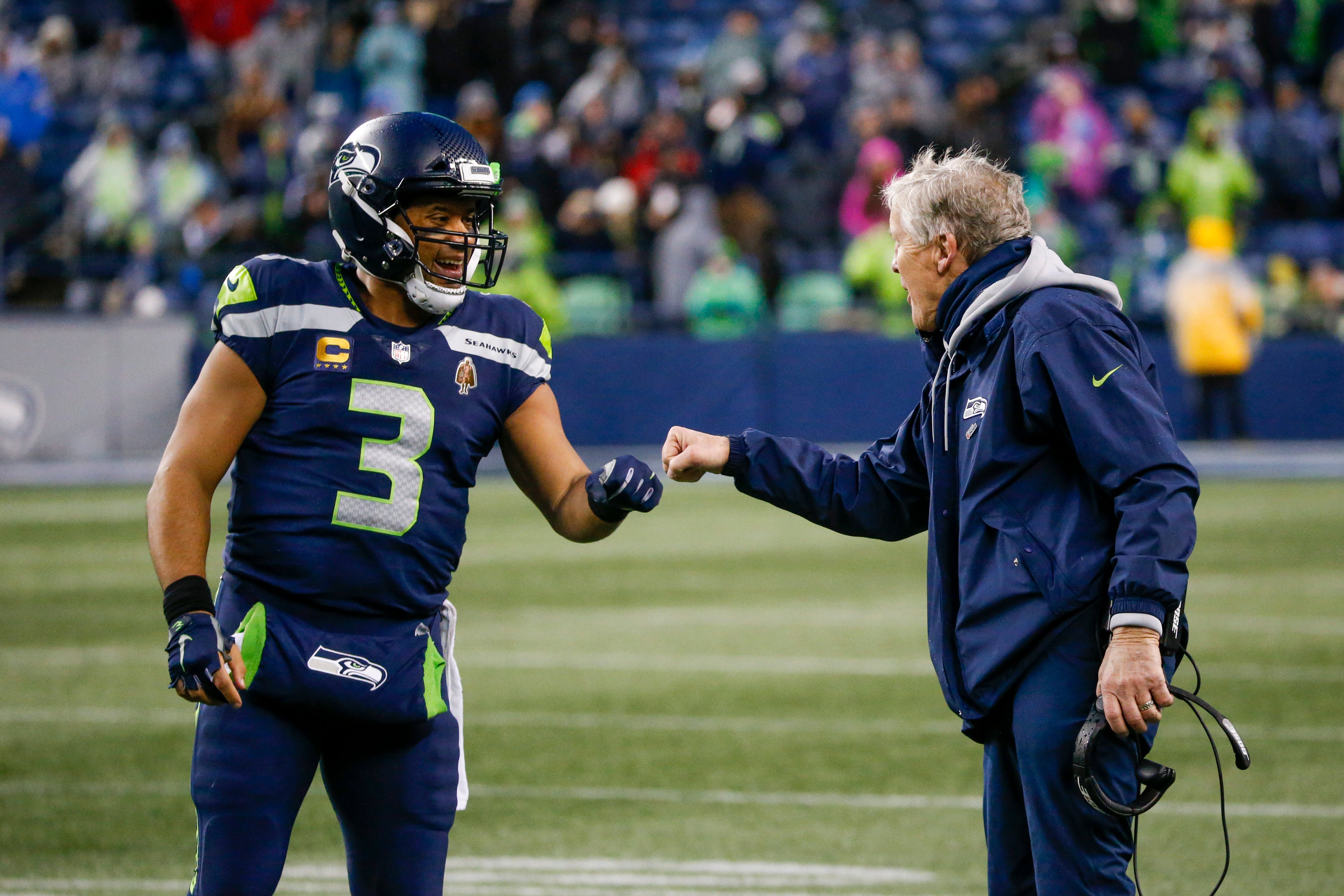 Jan 2, 2022; Seattle, Washington, USA; Seattle Seahawks quarterback Russell Wilson (3) bumps fists with head coach Pete Carroll during the fourth quarter two-minute warning against the Detroit Lions at Lumen Field.