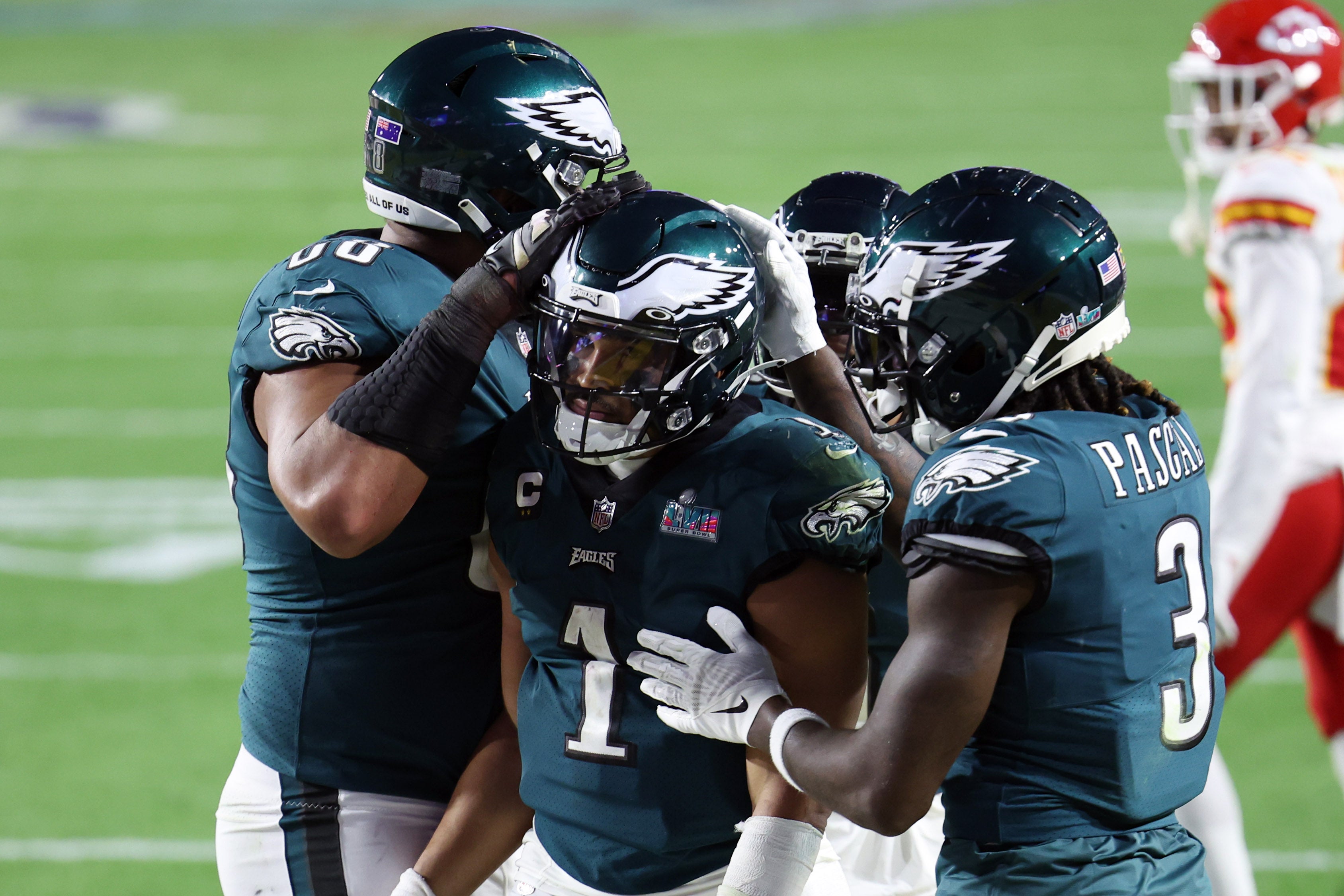 Feb 12, 2023; Glendale, Arizona, US; Philadelphia Eagles quarterback Jalen Hurts (1) celebrates with teammates after scoring a touchdown against the Kansas City Chiefs in the fourth quarter of Super Bowl LVII at State Farm Stadium.