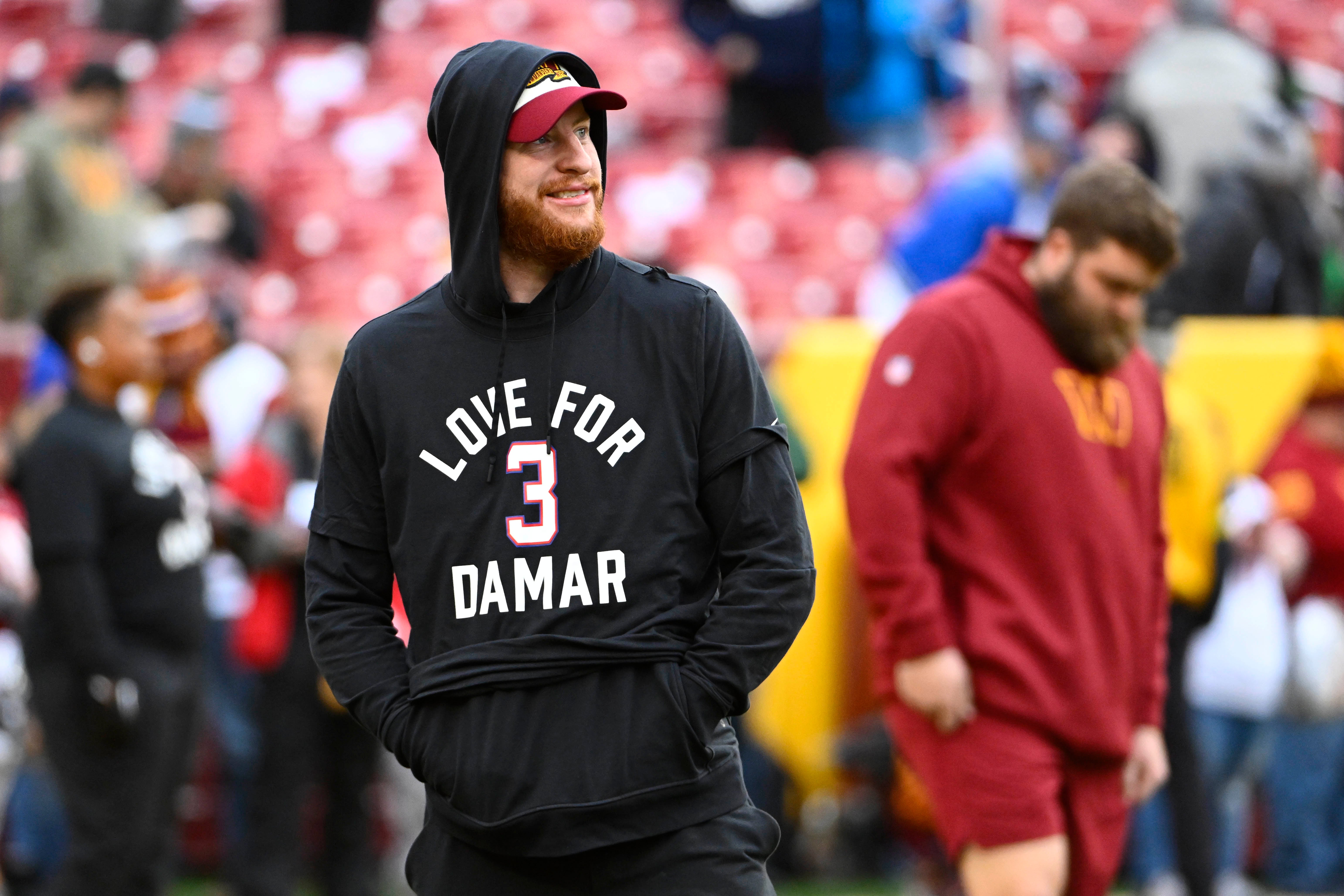 Jan 8, 2023; Landover, Maryland, USA; Washington Commanders quarterback Carson Wentz on the field wearing a shirt in support of Demar Hamlin before the game against the Dallas Cowboys at FedExField.