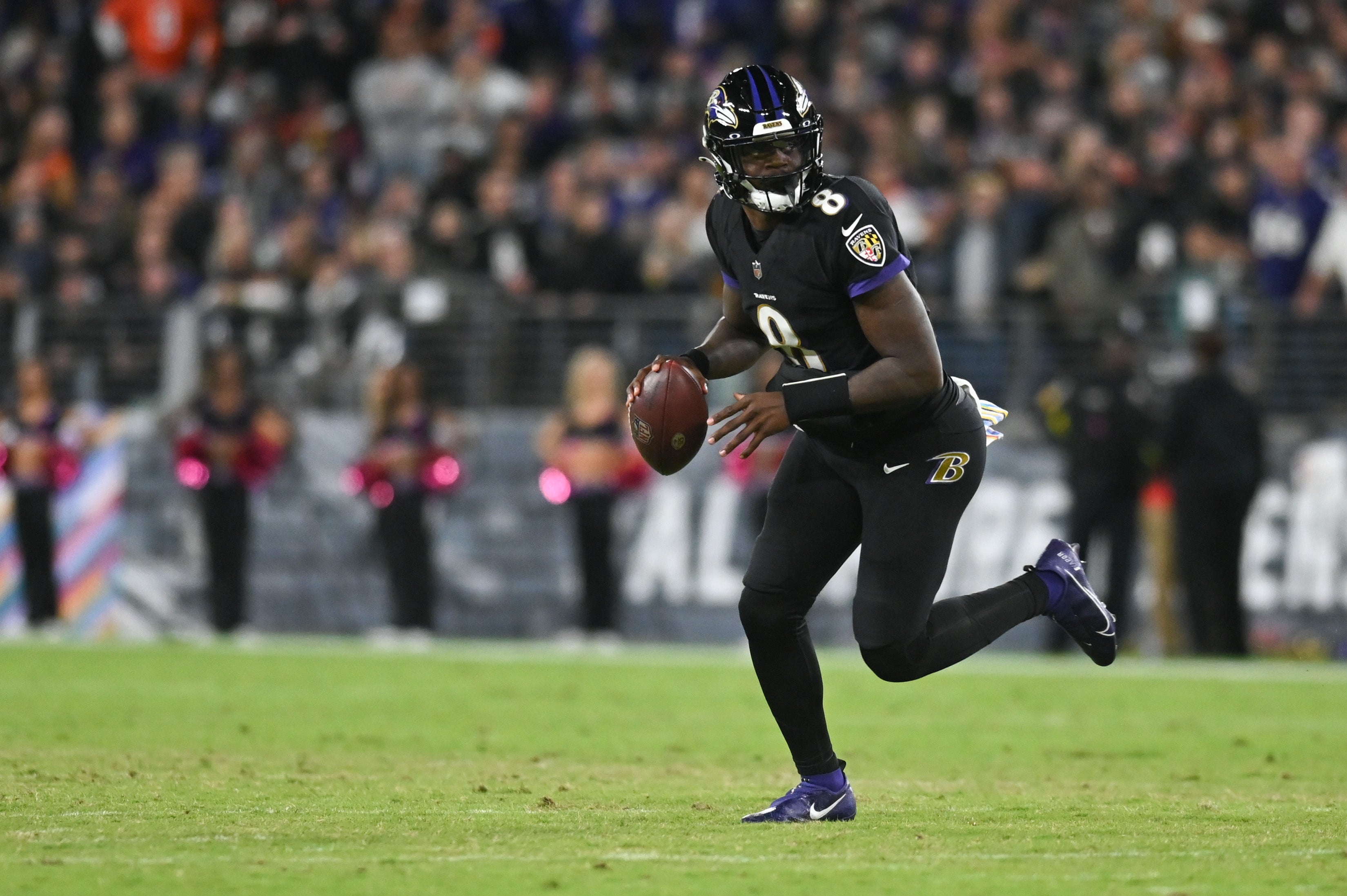 Oct 9, 2022; Baltimore, Maryland, USA; Baltimore Ravens quarterback Lamar Jackson (8) rolls out to pass during the game against the Cincinnati Bengals at M&T Bank Stadium. Mandatory Credit: Tommy Gilligan-USA TODAY Sports