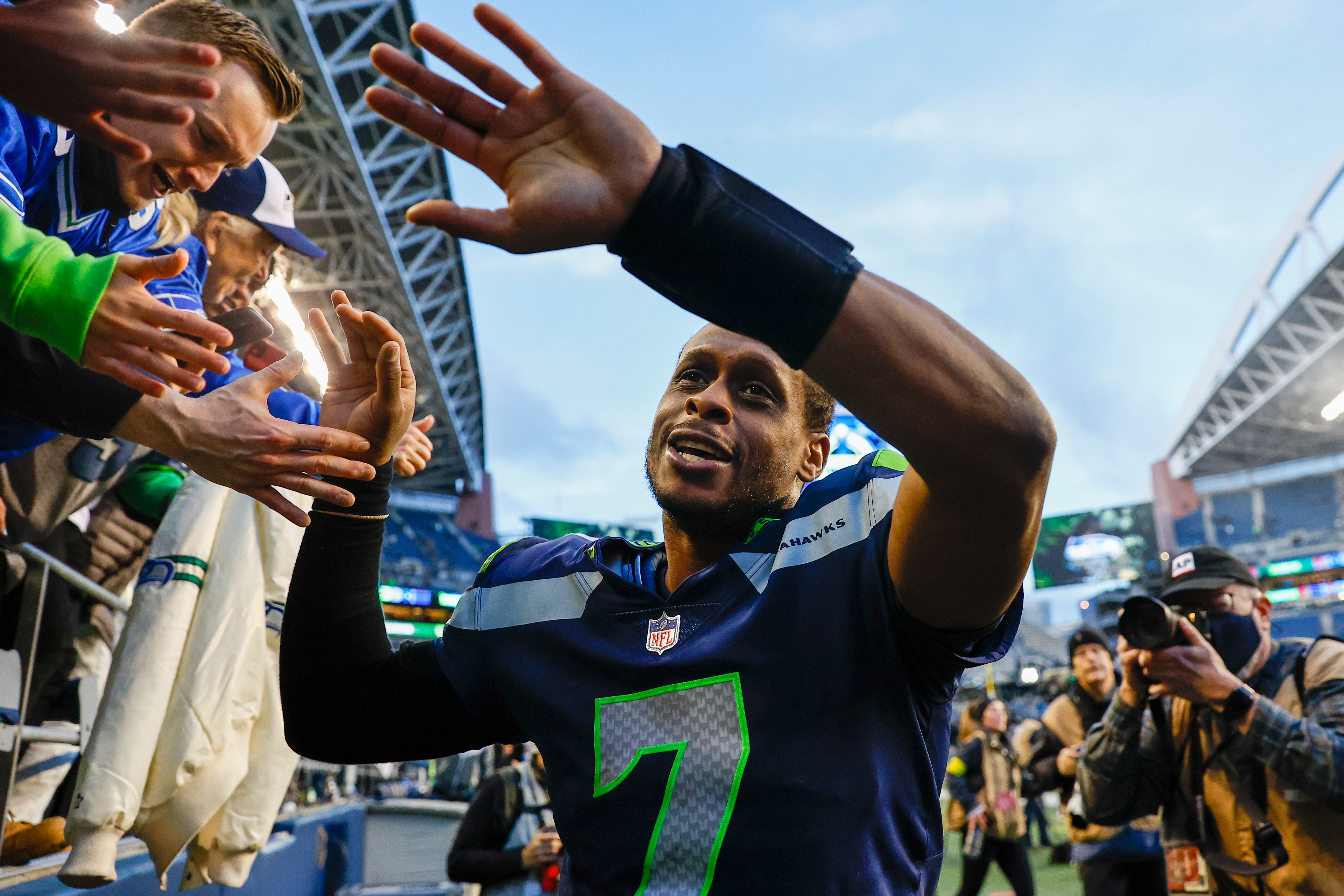 Jan 1, 2023; Seattle, Washington, USA; Seattle Seahawks quarterback Geno Smith (7) celebrates with fans following a 23-6 victory against the New York Jets at Lumen Field.