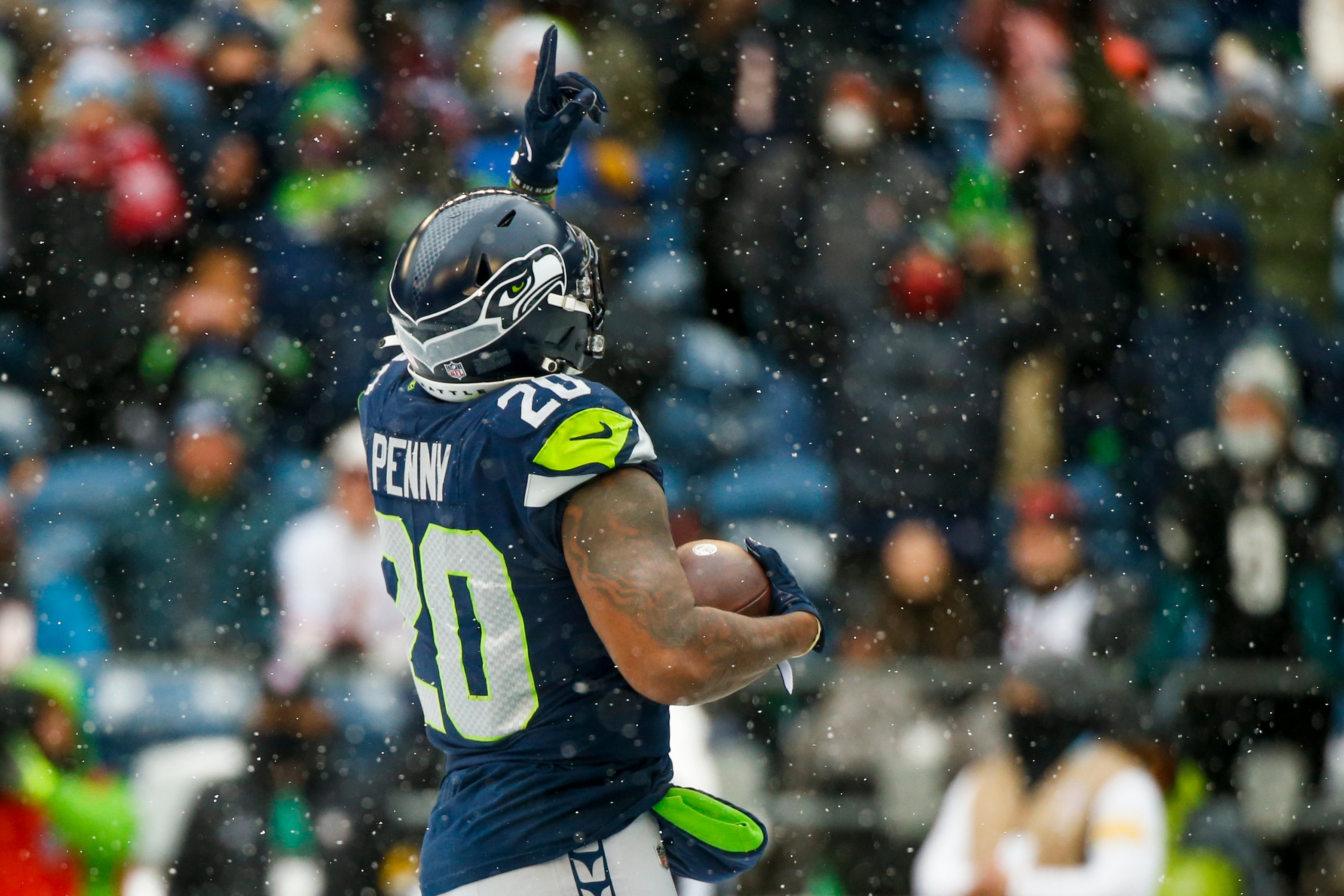 Dec 26, 2021; Seattle, Washington, USA; Seattle Seahawks running back Rashaad Penny (20) celebrates after rushing for a touchdown against the Chicago Bears during the second quarter at Lumen Field.