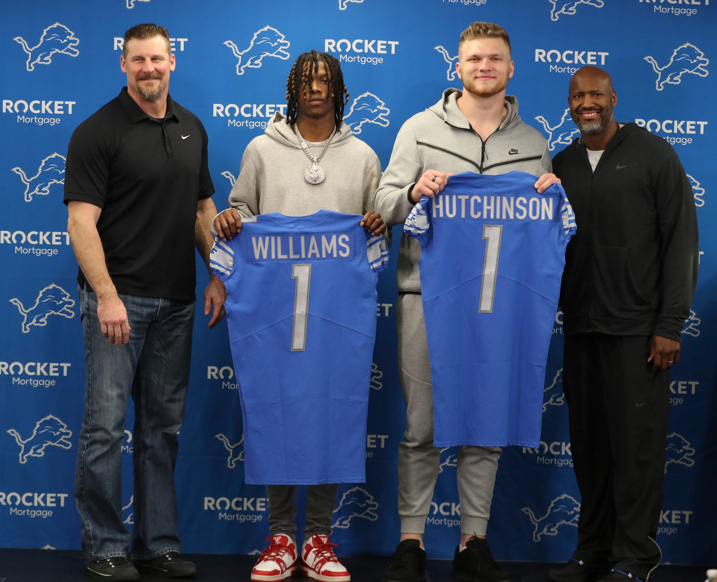 Detroit Lions head coach Dan Campbell, first round picks receiver Jamison Williams and defensive end Aidan Hutchinson pose for a picture with GM Brad Holmes during the press conference Friday, April 29, 2022 at the Detroit Lions practice facility in Allen Park. MAIN Lionspicks