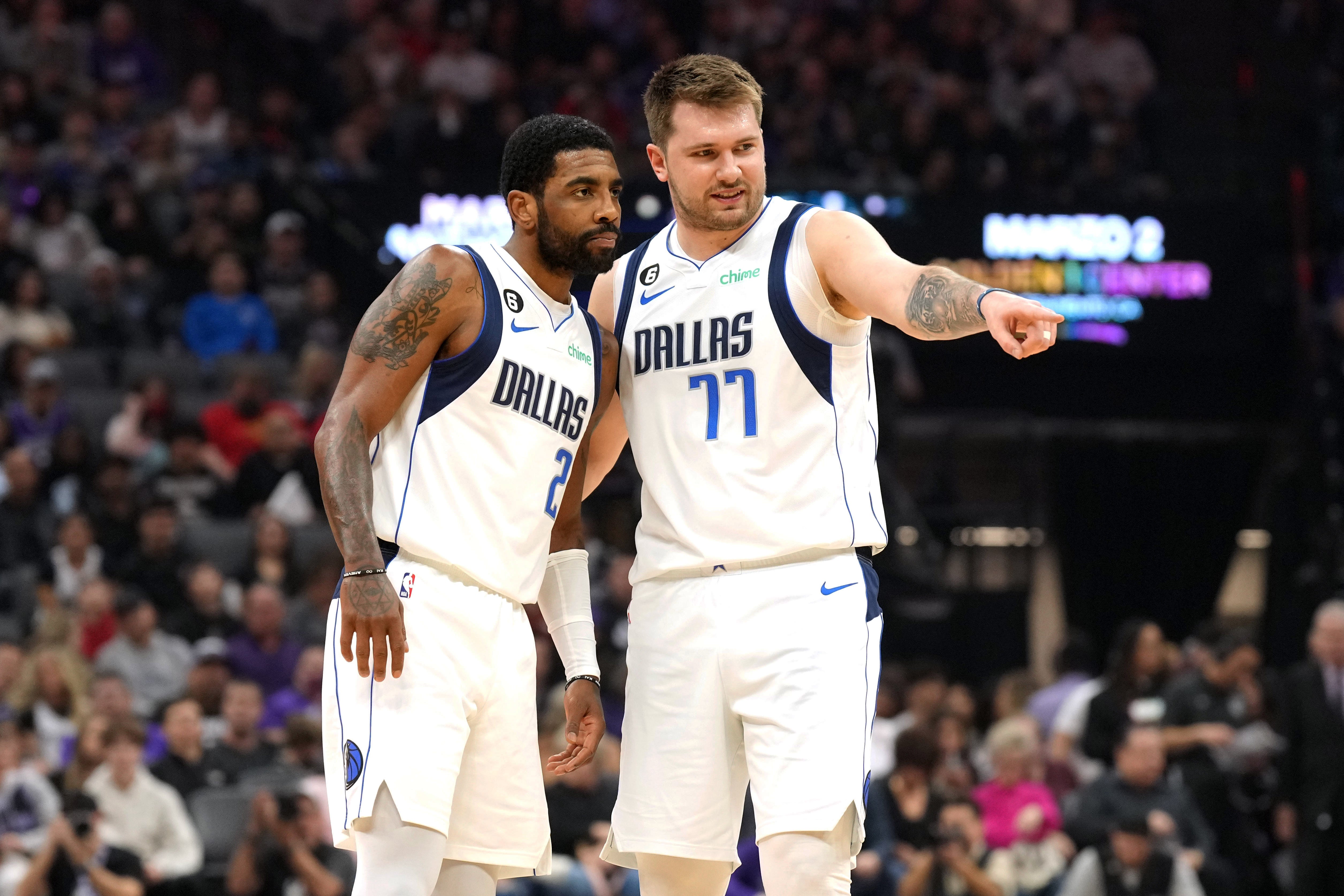 Feb 11, 2023; Sacramento, California, USA; Dallas Mavericks guard Kyrie Irving (2) and guard Luka Doncic (77) talk during the first quarter against the Sacramento Kings at Golden 1 Center.
