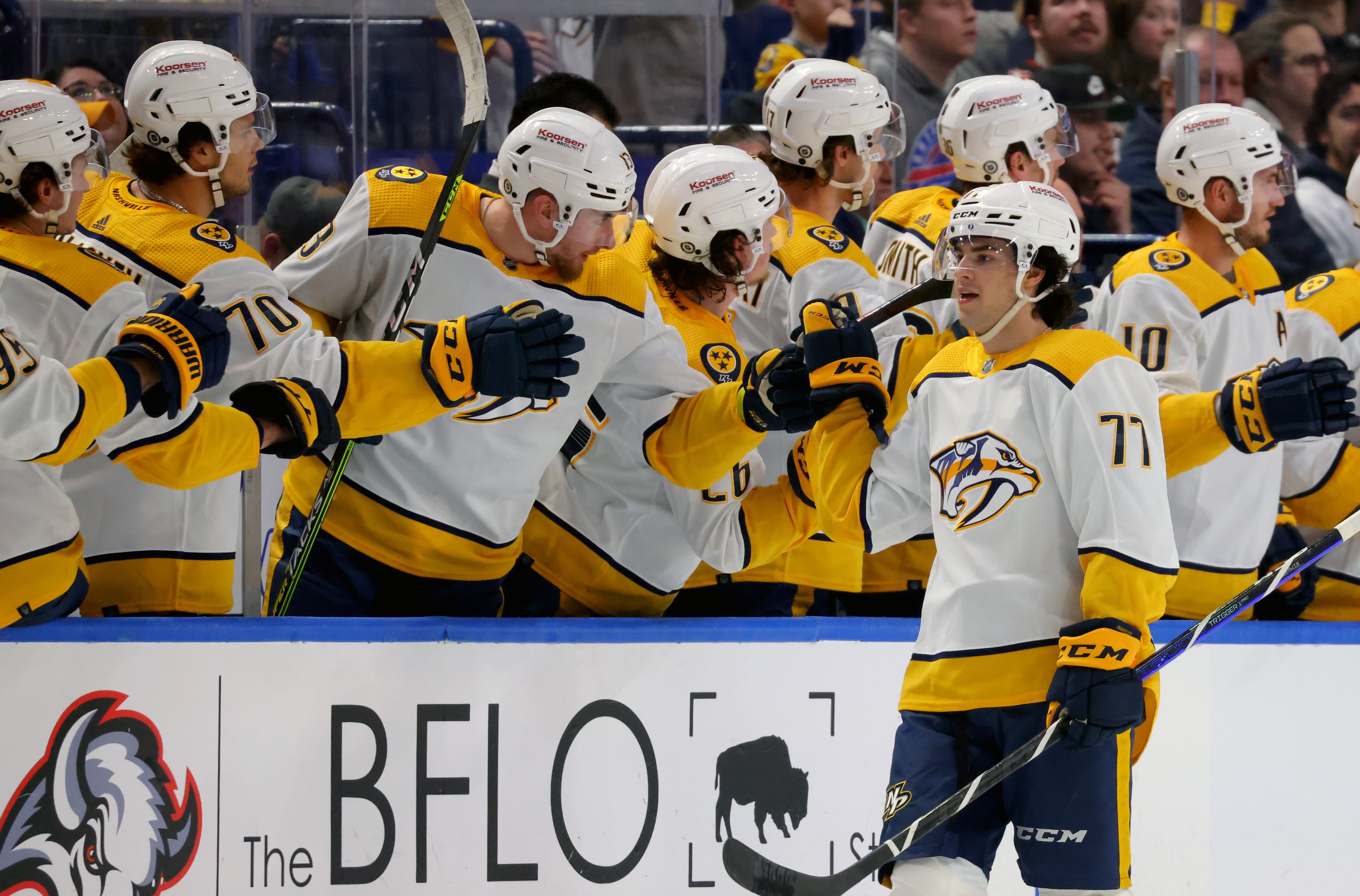 Nashville Predators forward Luke Evangelista celebrates with his teammates on the bench. He is currently fist bumping Yakov Trenin while Egor Afanasyev waits to be next, Colton Sissons is there.