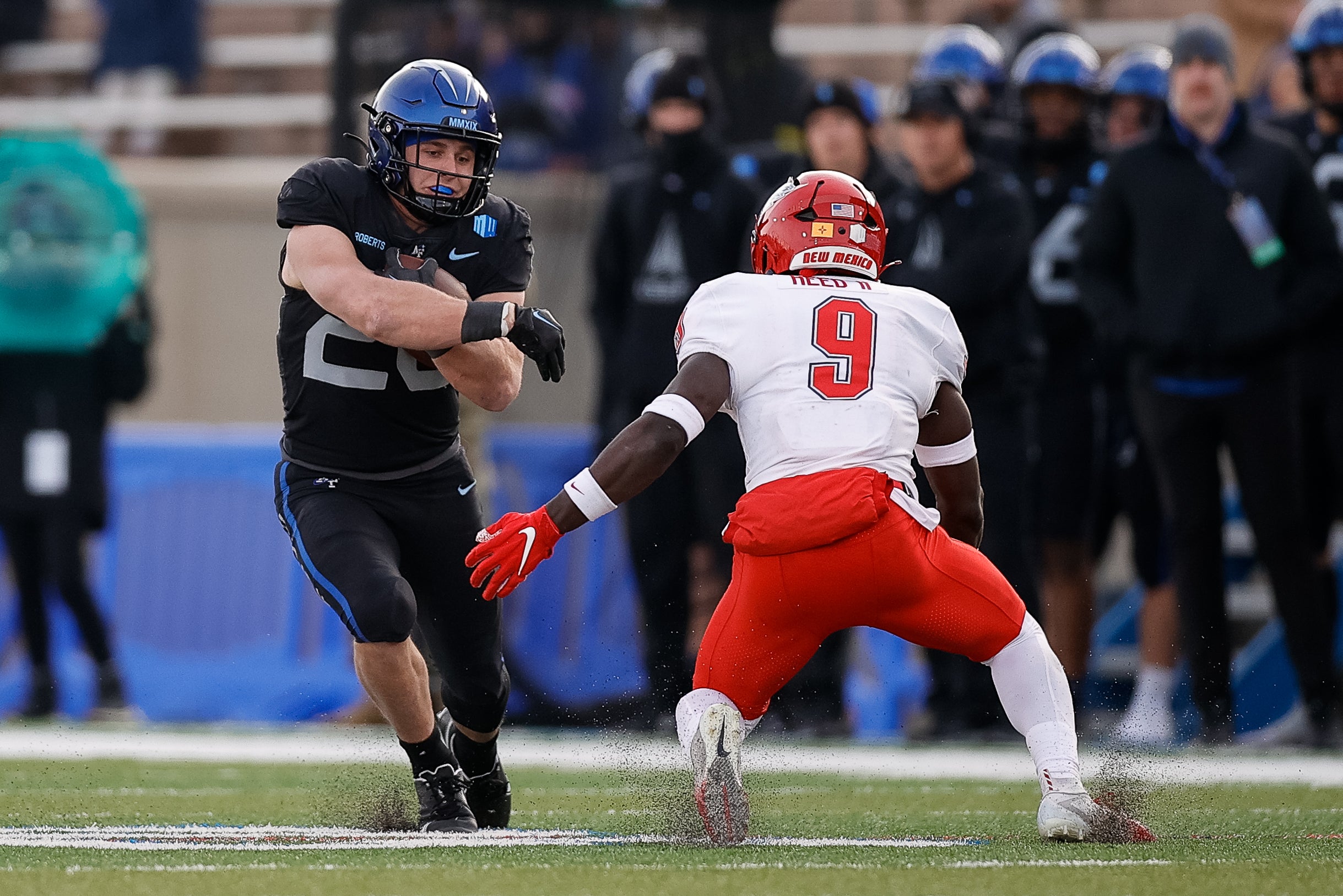Nov 12, 2022; Colorado Springs, Colorado, USA; Air Force Falcons running back Brad Roberts (20) runs the ball against New Mexico Lobos safety Jerrick Reed II (9) in the third quarter at Falcon Stadium.