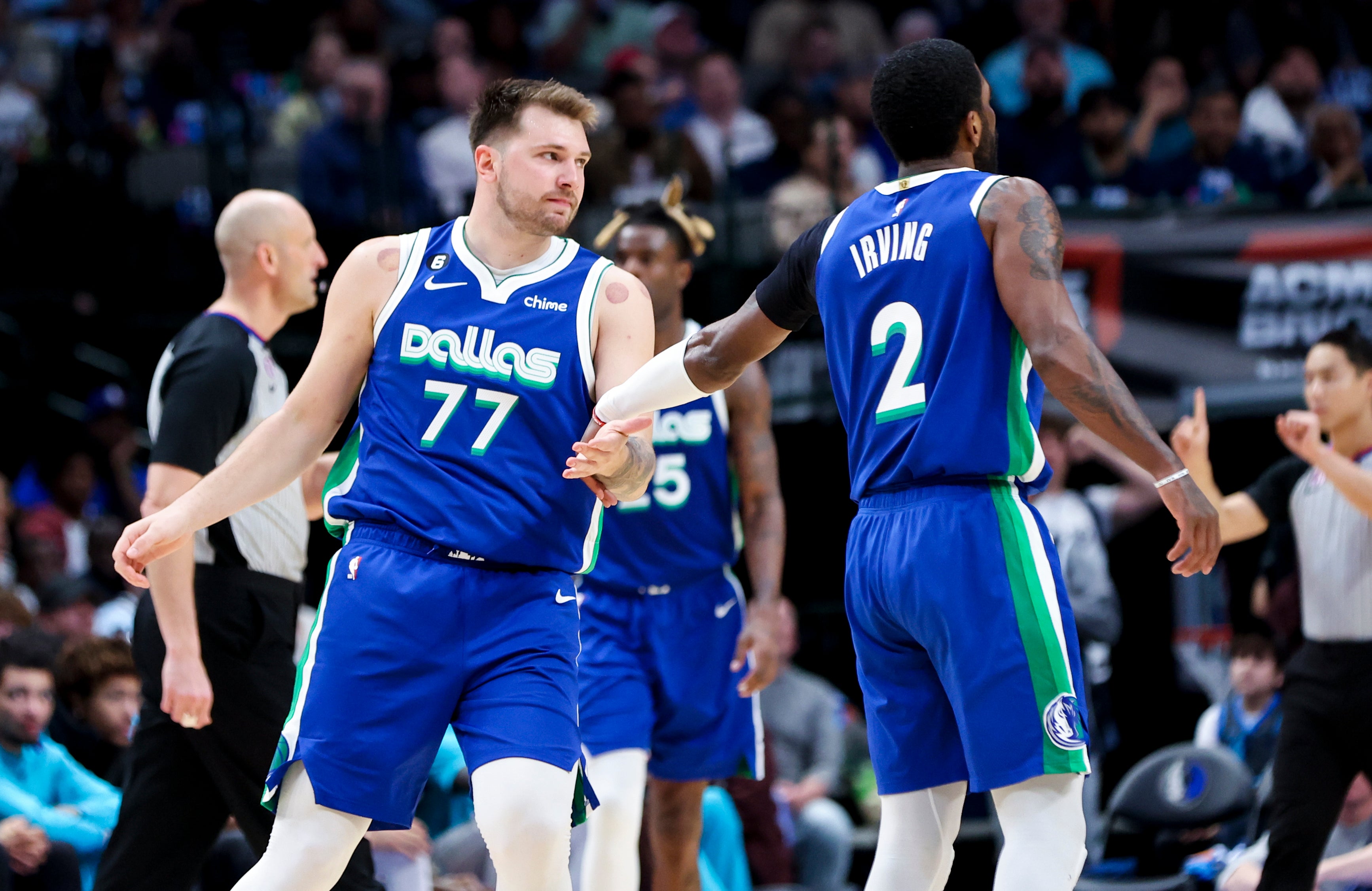 Mar 24, 2023; Dallas, Texas, USA; Dallas Mavericks guard Luka Doncic (77) celebrates with Dallas Mavericks guard Kyrie Irving (2) during the third quarter against the Charlotte Hornets at American Airlines Center.