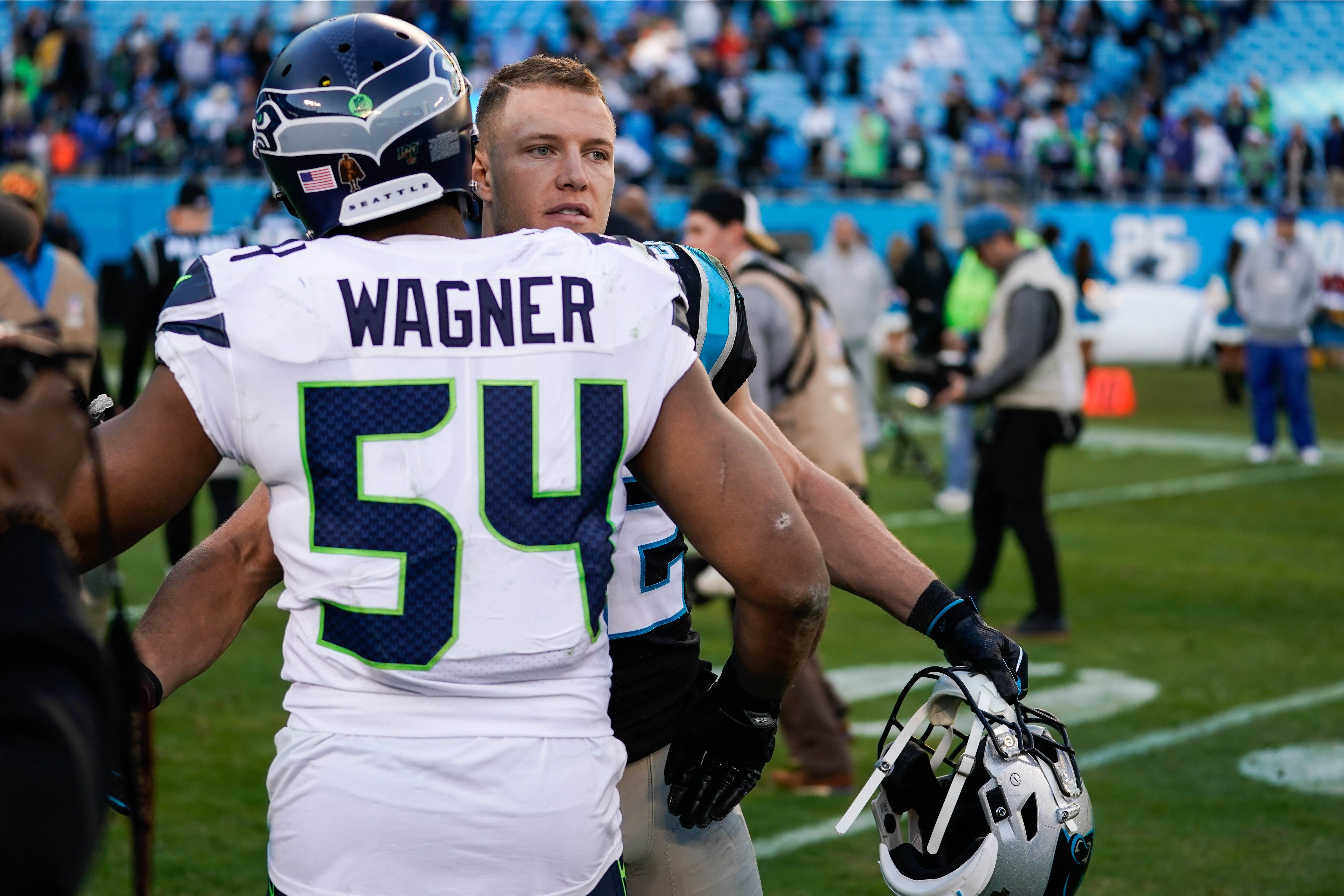 Dec 15, 2019; Charlotte, NC, USA; Carolina Panthers running back Christian McCaffrey (22) and Seattle Seahawks middle linebacker Bobby Wagner (54) after the game at Bank of America Stadium.