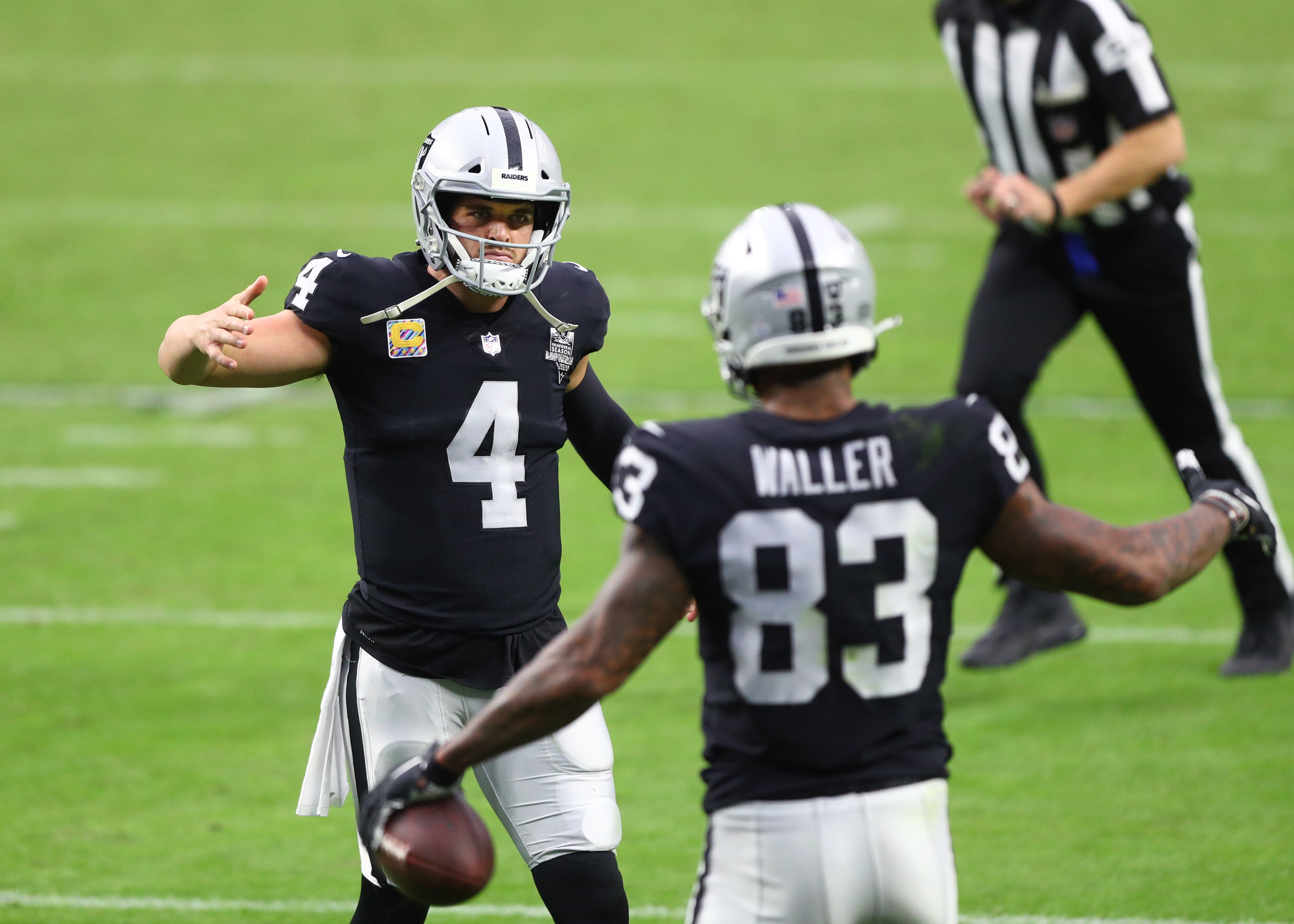 Oct 25, 2020; Paradise, Nevada, USA; Las Vegas Raiders quarterback Derek Carr (4) celebrates a touchdown with tight end Darren Waller (83) against the Tampa Bay Buccaneers at Allegiant Stadium.