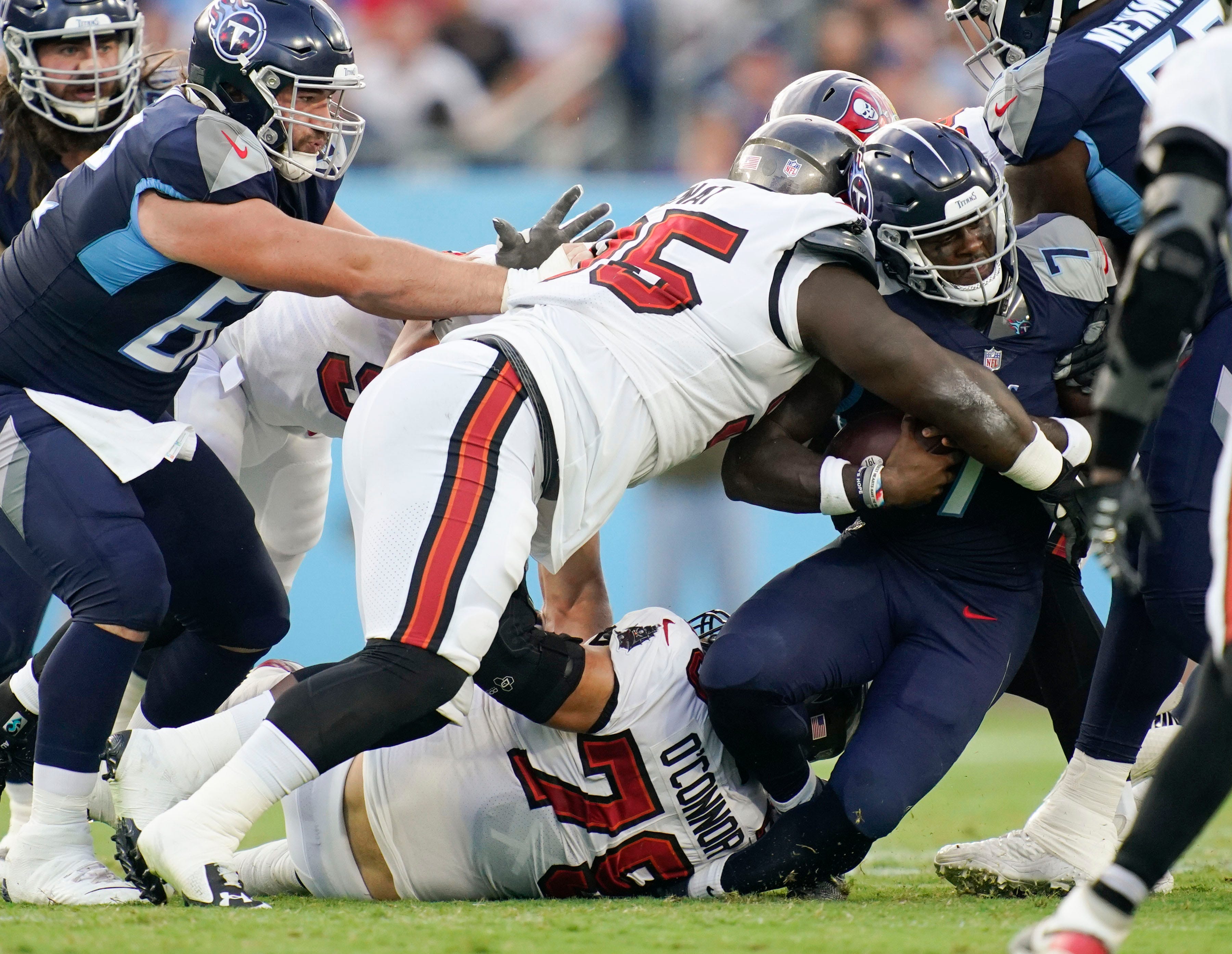 Tennessee Titans quarterback Malik Willis (7) is tackled by Tampa Bay Buccaneers defensive tackle Deadrin Senat (95) during the first quarter of a preseason game at Nissan Stadium Saturday, Aug. 20, 2022, in Nashville, Tenn. Nfl Tampa Bay Buccaneers At Tennessee Titans