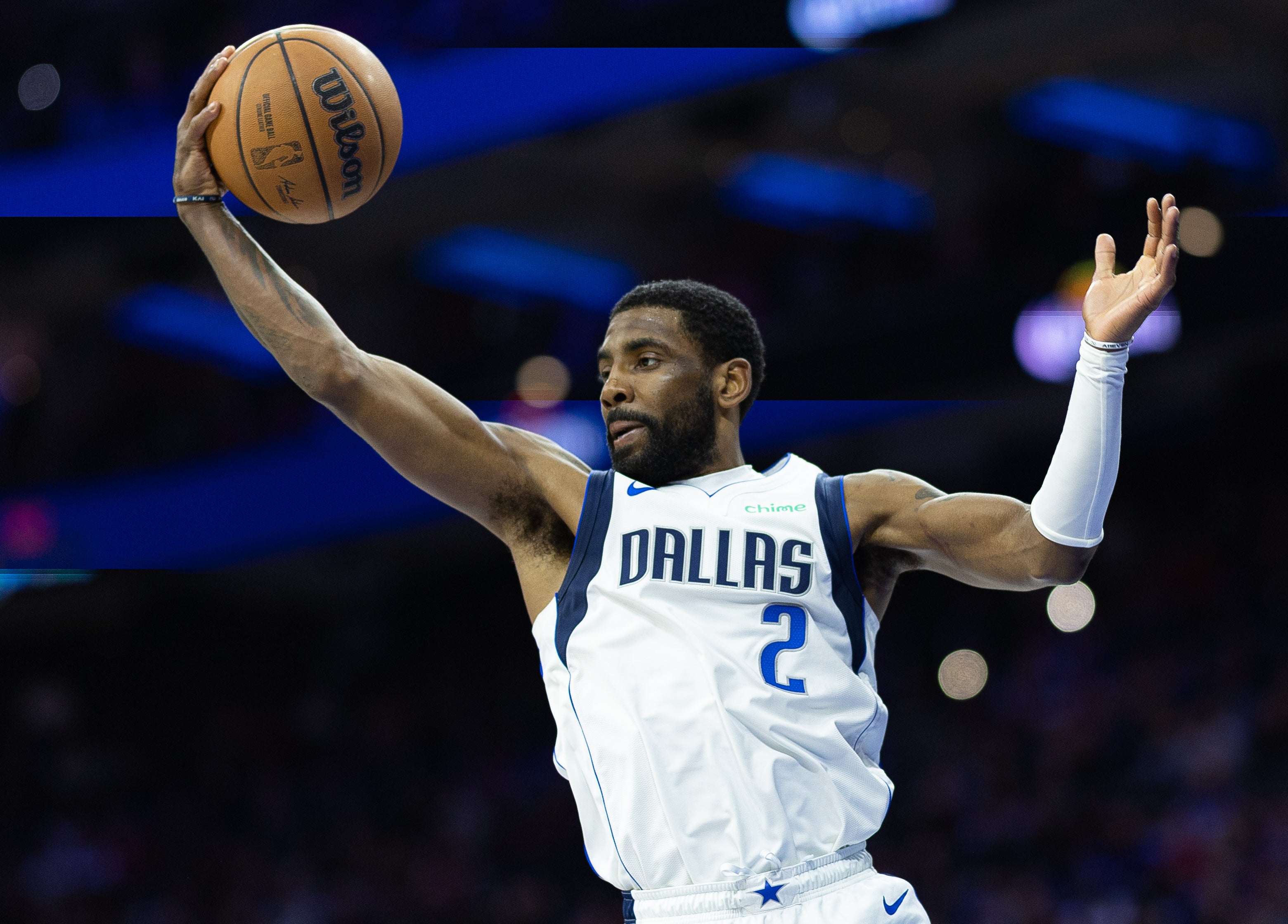 Mar 29, 2023; Philadelphia, Pennsylvania, USA; Dallas Mavericks guard Kyrie Irving (2) reaches for a rebound against the Philadelphia 76ers during the fourth quarter at Wells Fargo Center.