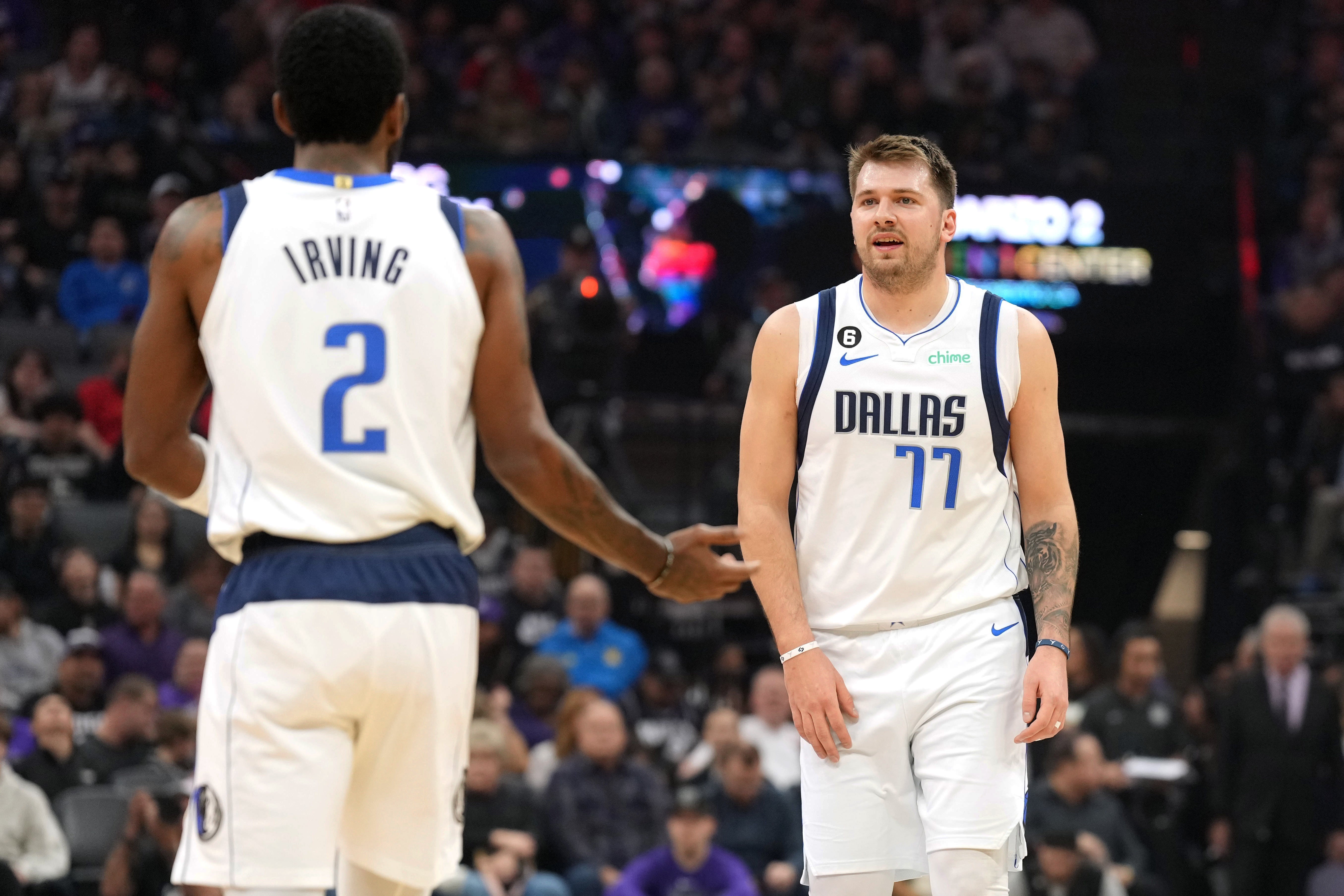 Feb 11, 2023; Sacramento, California, USA; Dallas Mavericks guard Kyrie Irving (2) and guard Luka Doncic (77) talk during the first quarter against the Sacramento Kings at Golden 1 Center.