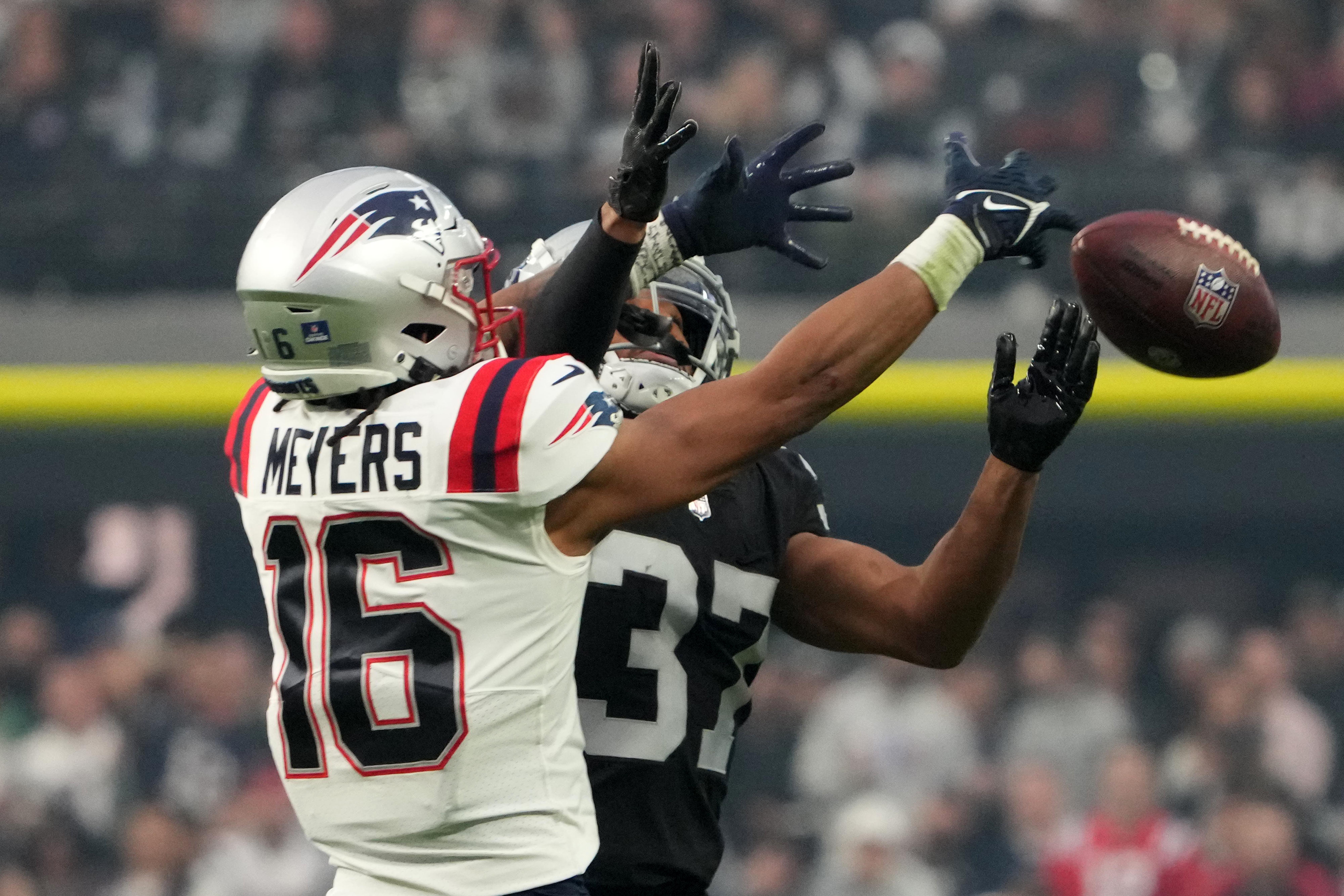 Dec 18, 2022; Paradise, Nevada, USA; New England Patriots wide receiver Jakobi Meyers (16) attempts to catch the ball against Las Vegas Raiders cornerback Tyler Hall (37) in the second half at Allegiant Stadium. The Raiders defeated the Patriots 30-24.