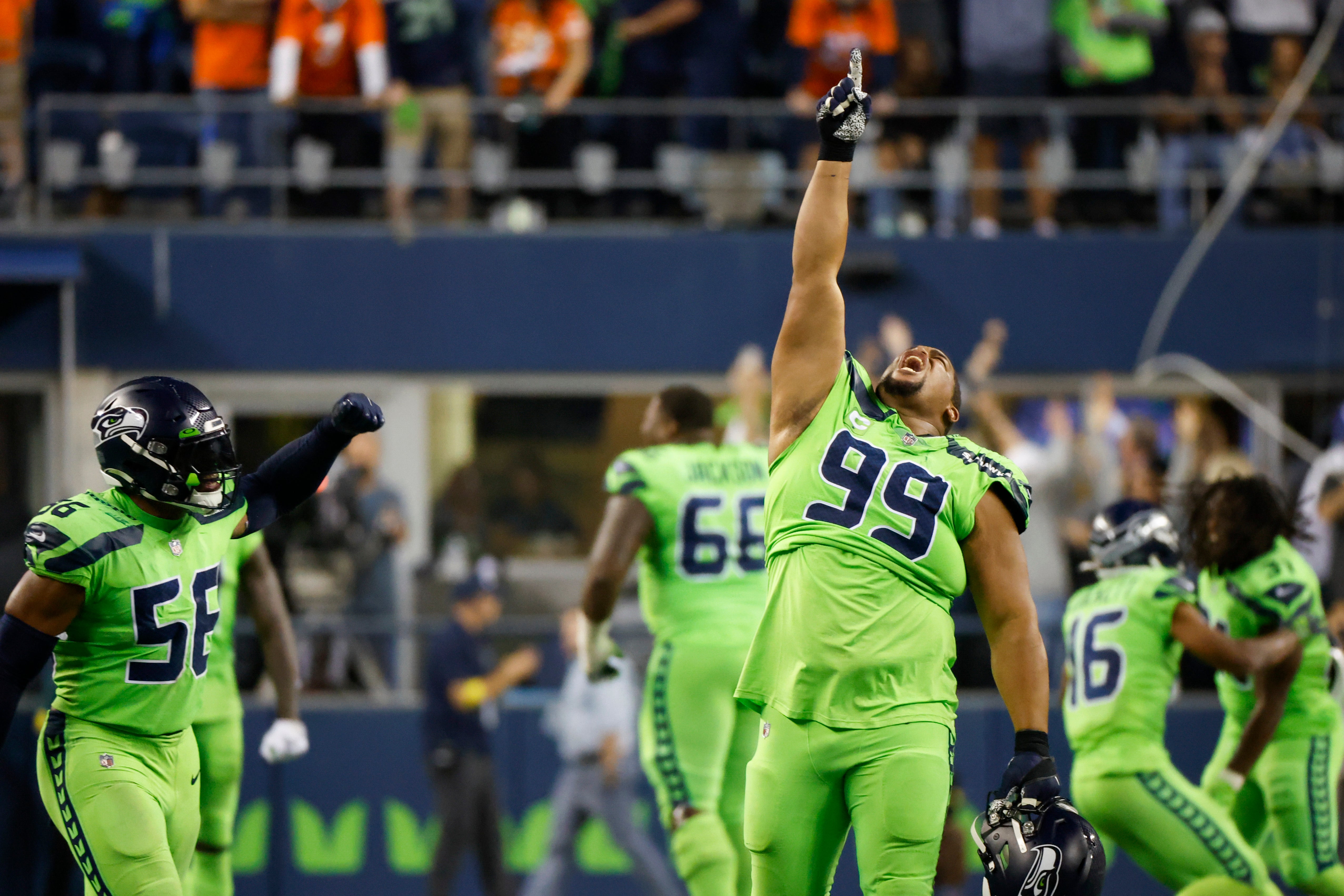 Sep 12, 2022; Seattle, Washington, USA; Seattle Seahawks defensive tackle Al Woods (99) and linebacker Jordyn Brooks (56) celebrate following a missed field goal against the Denver Broncos during the fourth quarter at Lumen Field.