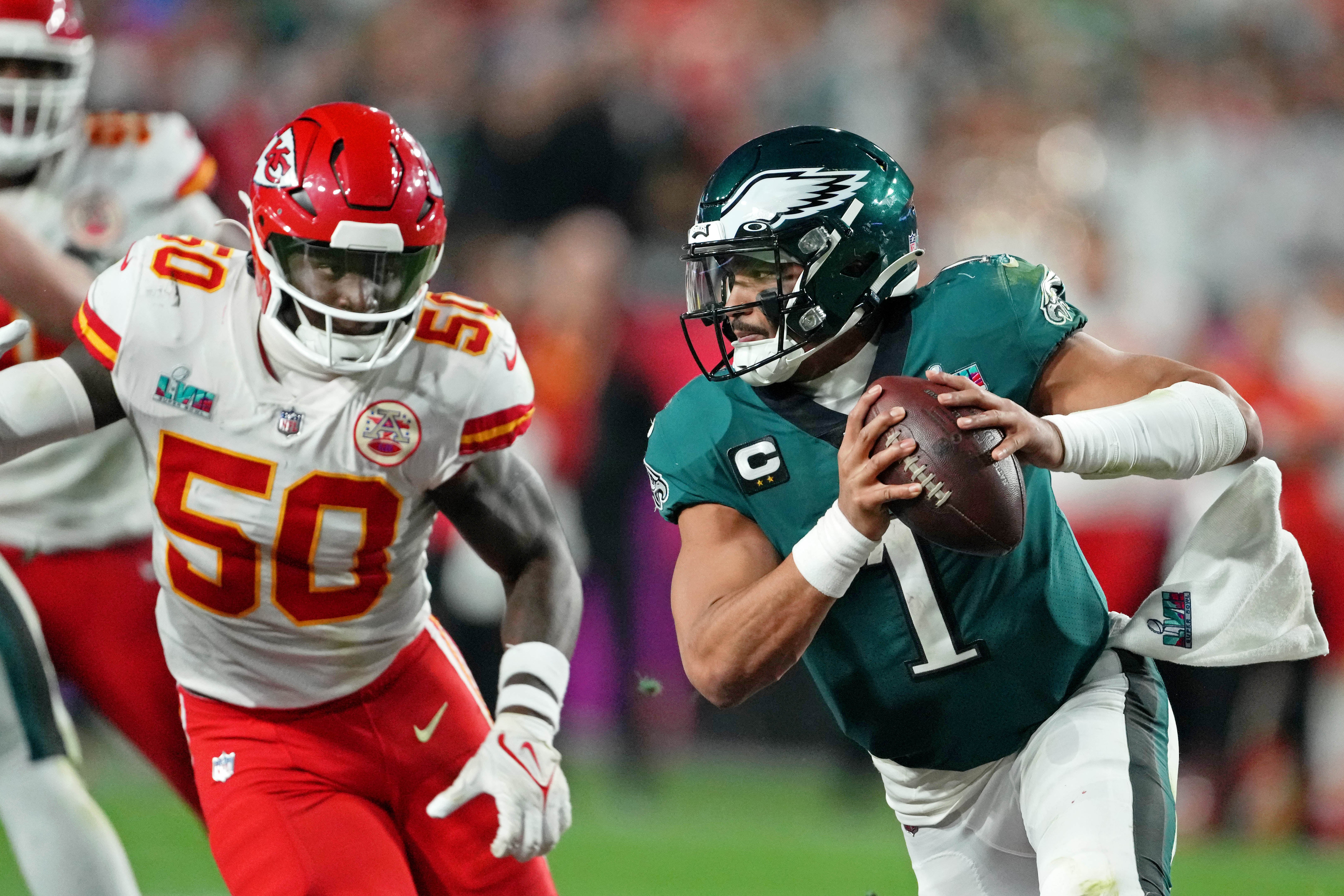 Feb 12, 2023; Glendale, Arizona, US; Philadelphia Eagles quarterback Jalen Hurts (1) scrambles with the ball against Kansas City Chiefs linebacker Willie Gay (50) during the fourth quarter of Super Bowl LVII at State Farm Stadium.