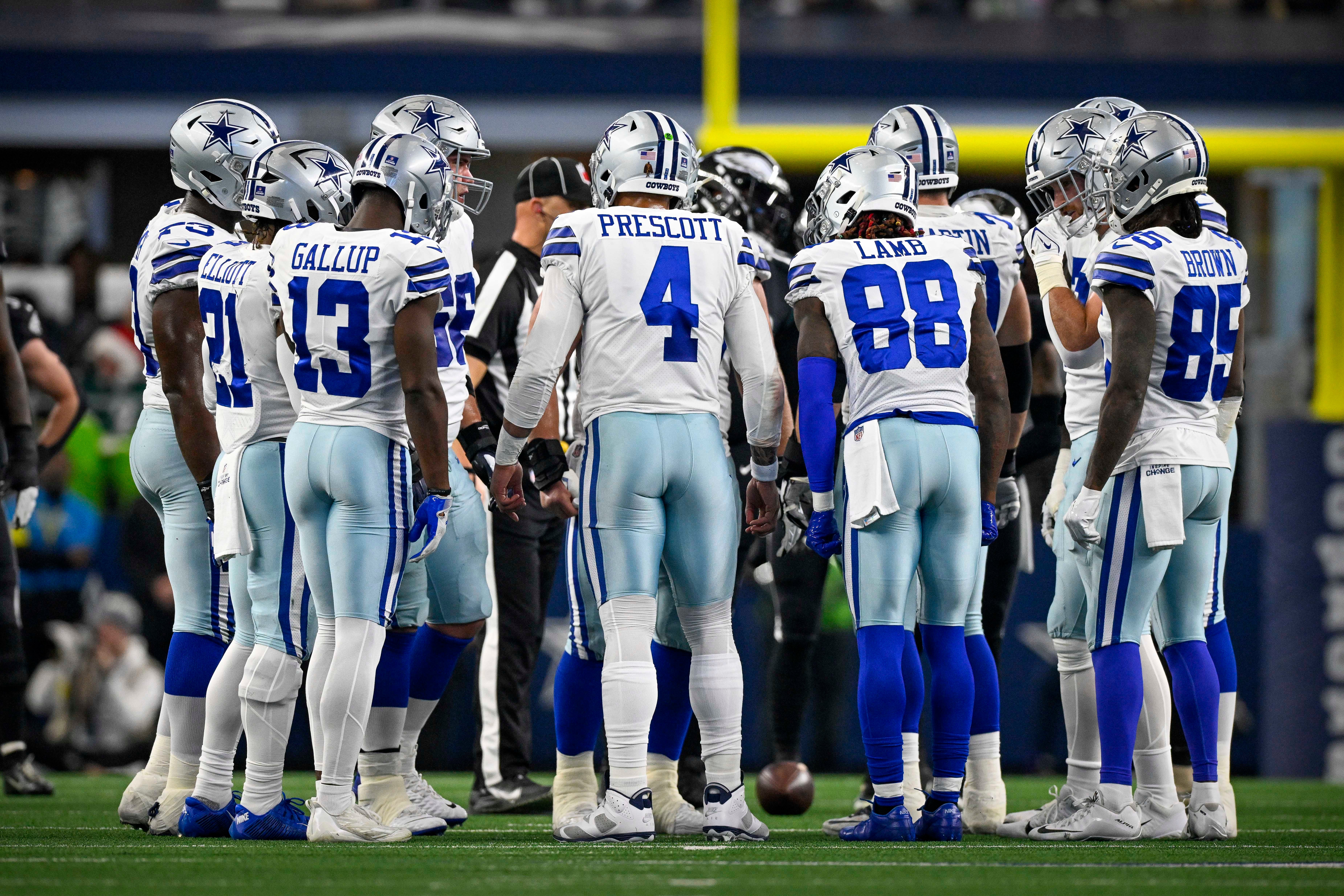Dec 24, 2022; Arlington, Texas, USA; Dallas Cowboys running back Ezekiel Elliott (21) and wide receiver Michael Gallup (13) and wide receiver CeeDee Lamb (88) and wide receiver Noah Brown (85) in the huddle during the game between the Dallas Cowboys and the Philadelphia Eagles at AT&T Stadium. Mandatory Credit: Jerome Miron-USA TODAY Sports