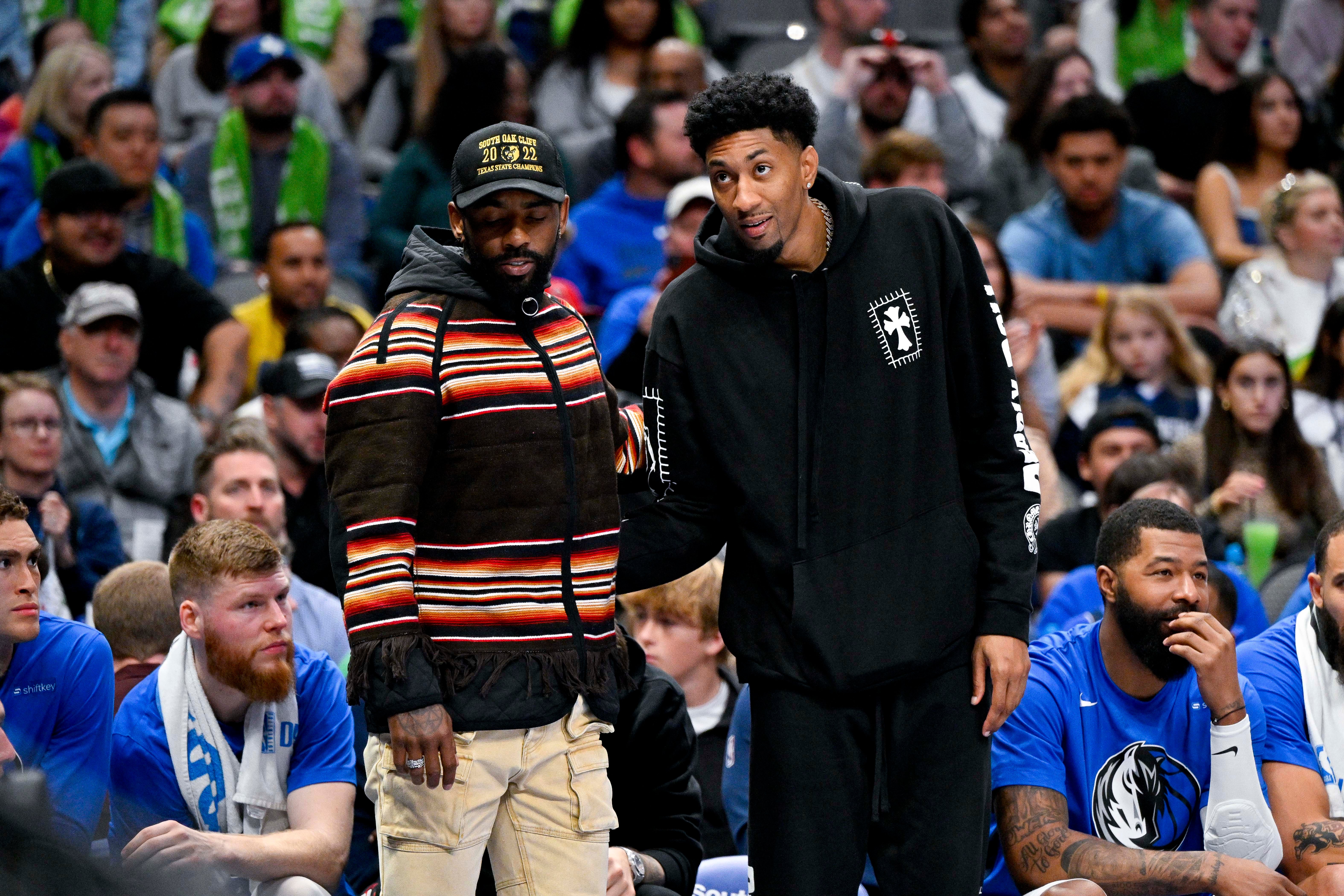 Apr 7, 2023; Dallas, Texas, USA; Dallas Mavericks guard Kyrie Irving (left) talks with Dallas Mavericks forward Christian Wood (right) during the second half at the American Airlines Center.