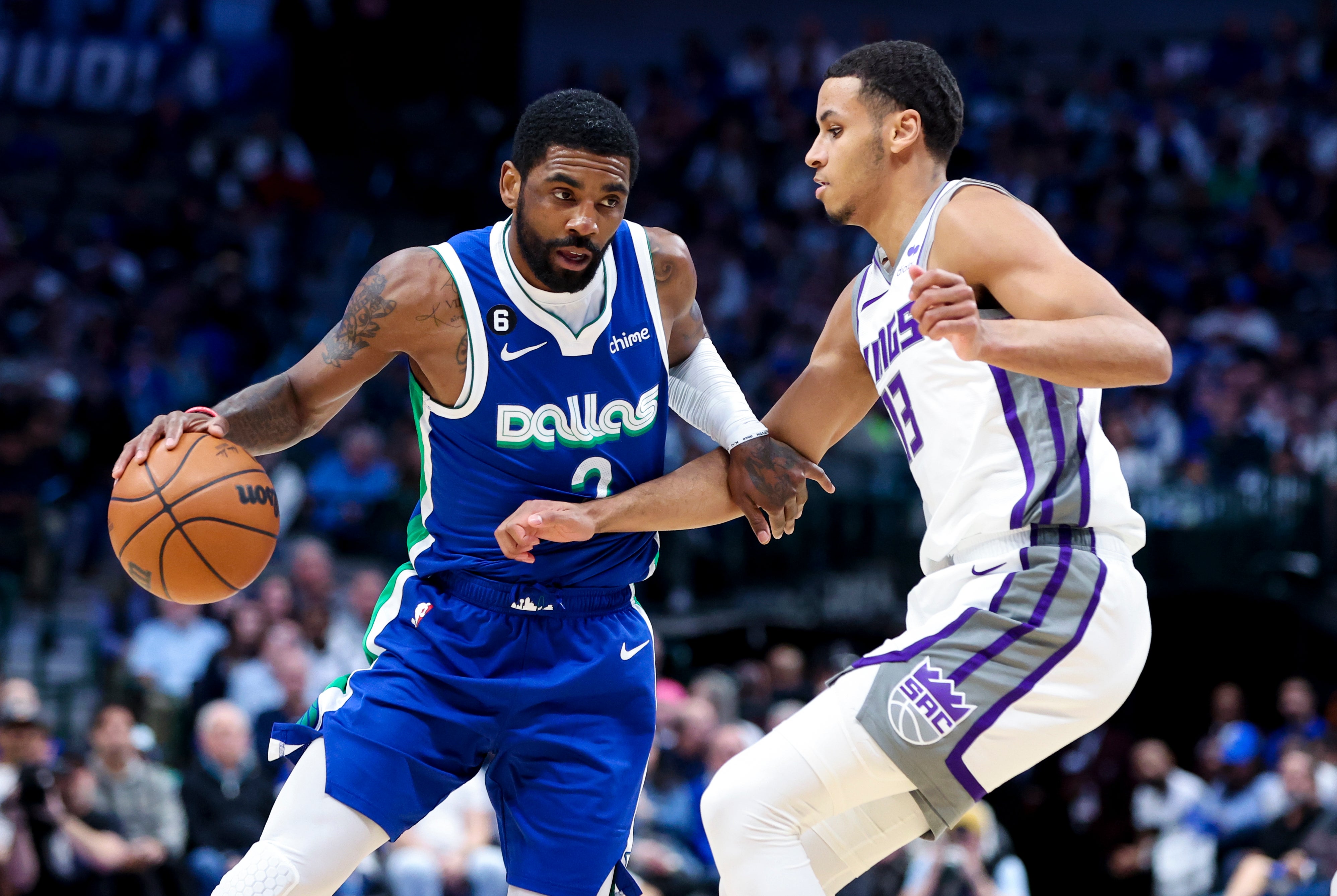 Apr 5, 2023; Dallas, Texas, USA; Dallas Mavericks guard Kyrie Irving (2) drives to the basket as Sacramento Kings forward Keegan Murray (13) defends during the first half at American Airlines Center.