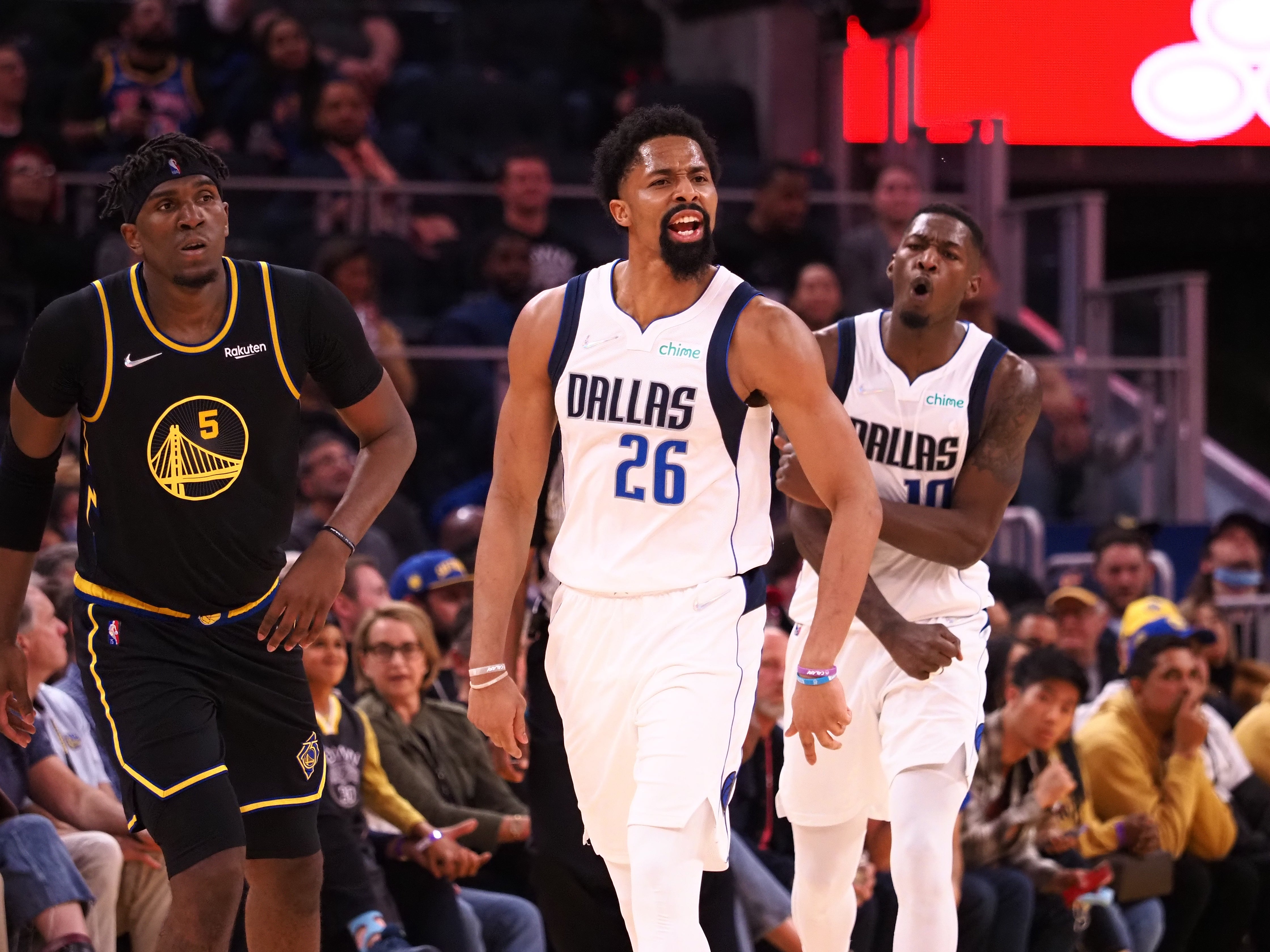 Feb 27, 2022; San Francisco, California, USA; Dallas Mavericks guard Spencer Dinwiddie (26) celebrates ahead of forward Dorian Finney-Smith (10) and Golden State Warriors forward Kevon Looney (5) after scoring a basket during the fourth quarter at Chase Center.