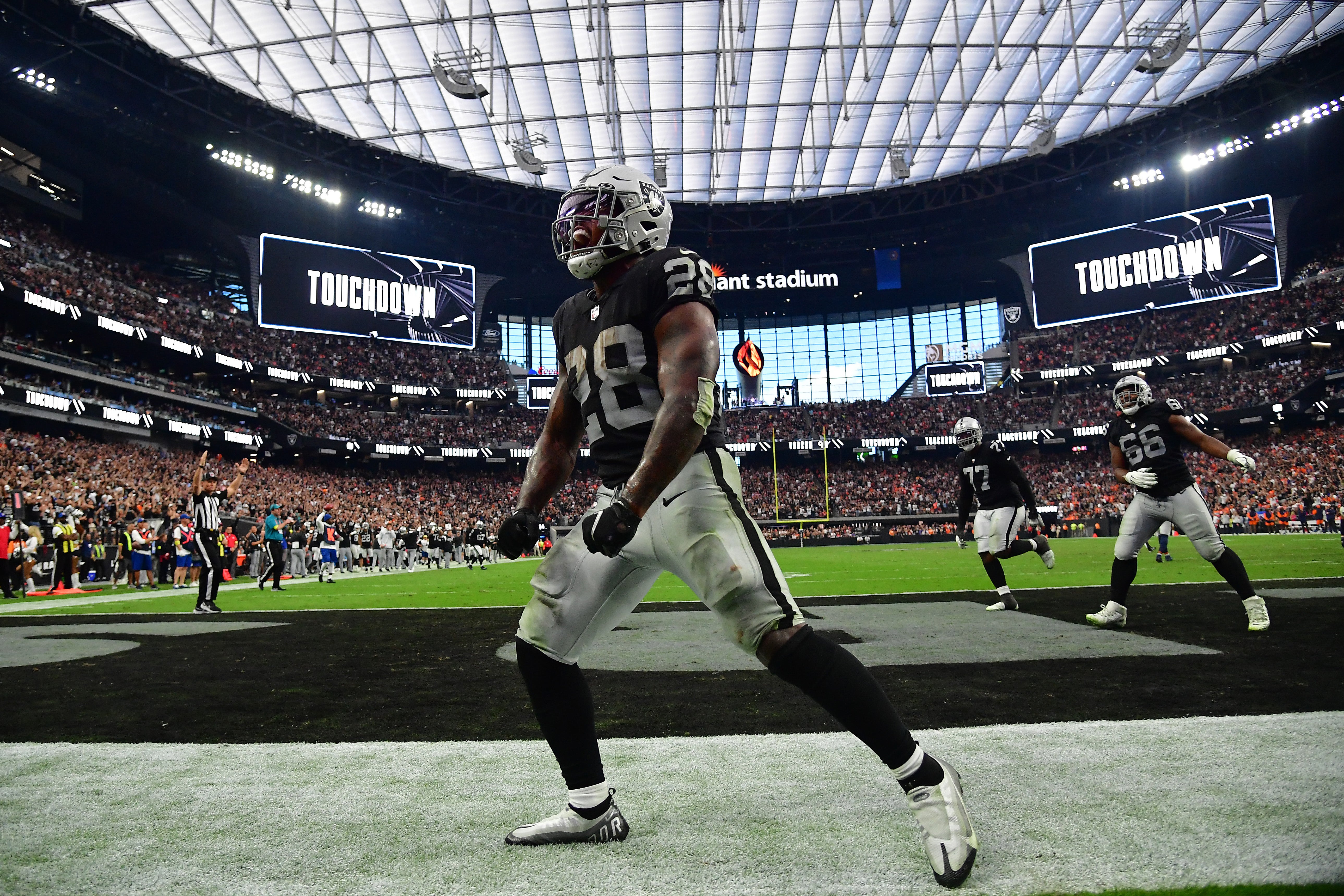 Oct 2, 2022; Paradise, Nevada, USA; Las Vegas Raiders running back Josh Jacobs (28) celebrates his touchdown scored against the Denver Broncos during the second half at Allegiant Stadium.