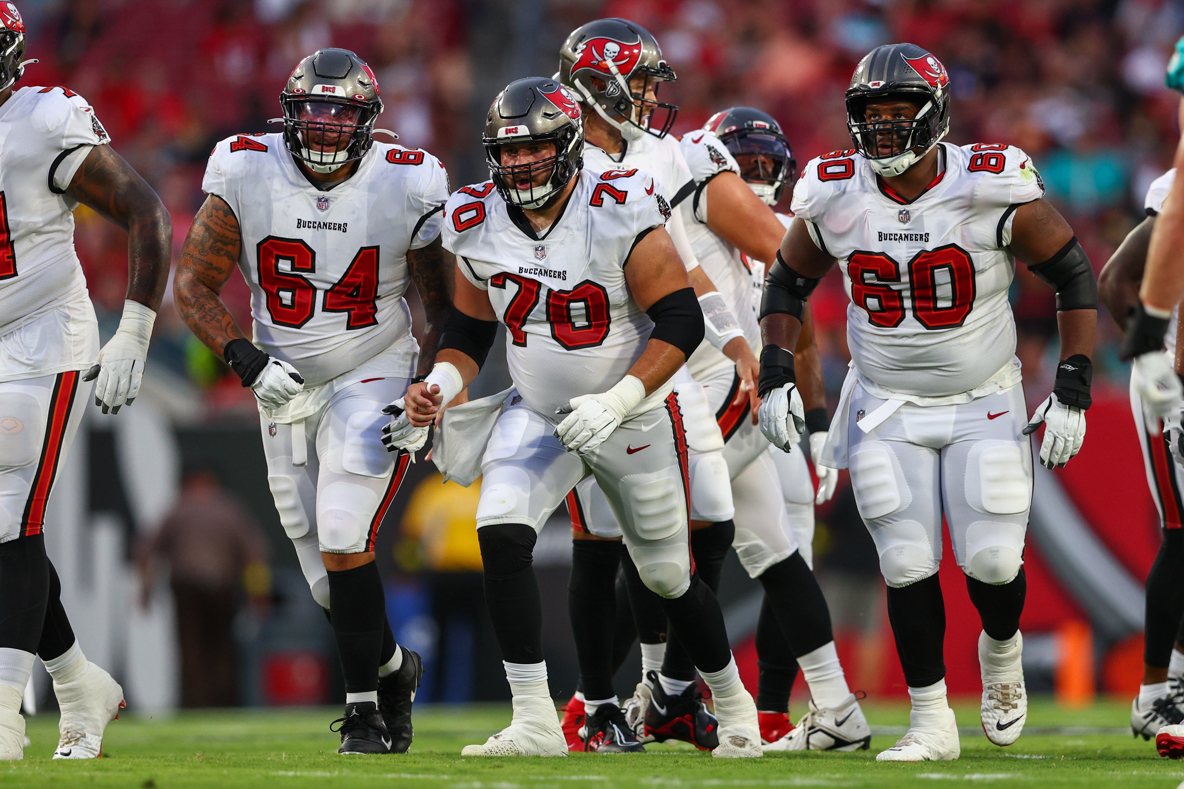 Aug 13, 2022; Tampa, Florida, USA; Tampa Bay Buccaneers offensive tackle Robert Hainsey (70) leads out of he huddle against the Miami Dolphins in the first quarter during preseason at Raymond James Stadium. Mandatory Credit: Nathan Ray Seebeck-USA TODAY Sports