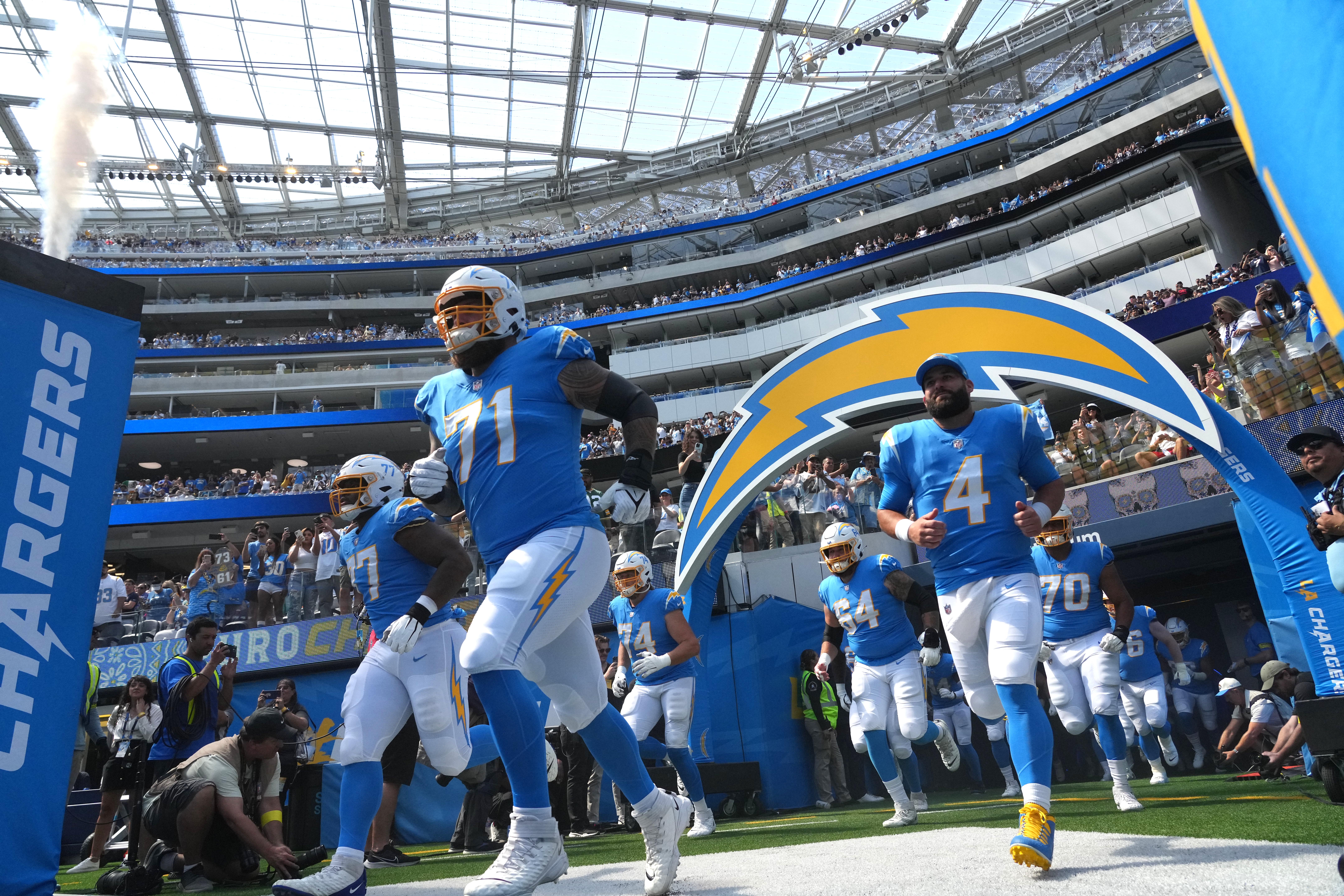 Sep 25, 2022; Inglewood, California, USA; A general overall view as Los Angeles Chargers guard Zion Johnson (77), guard Matt Feiler (71), linebacker Carlo Kemp (54) and quarterback Chase Daniel (4) head onto the field before the game against the Jacksonville Jaguars at SoFi Stadium. Mandatory Credit: Kirby Lee-USA TODAY Sports