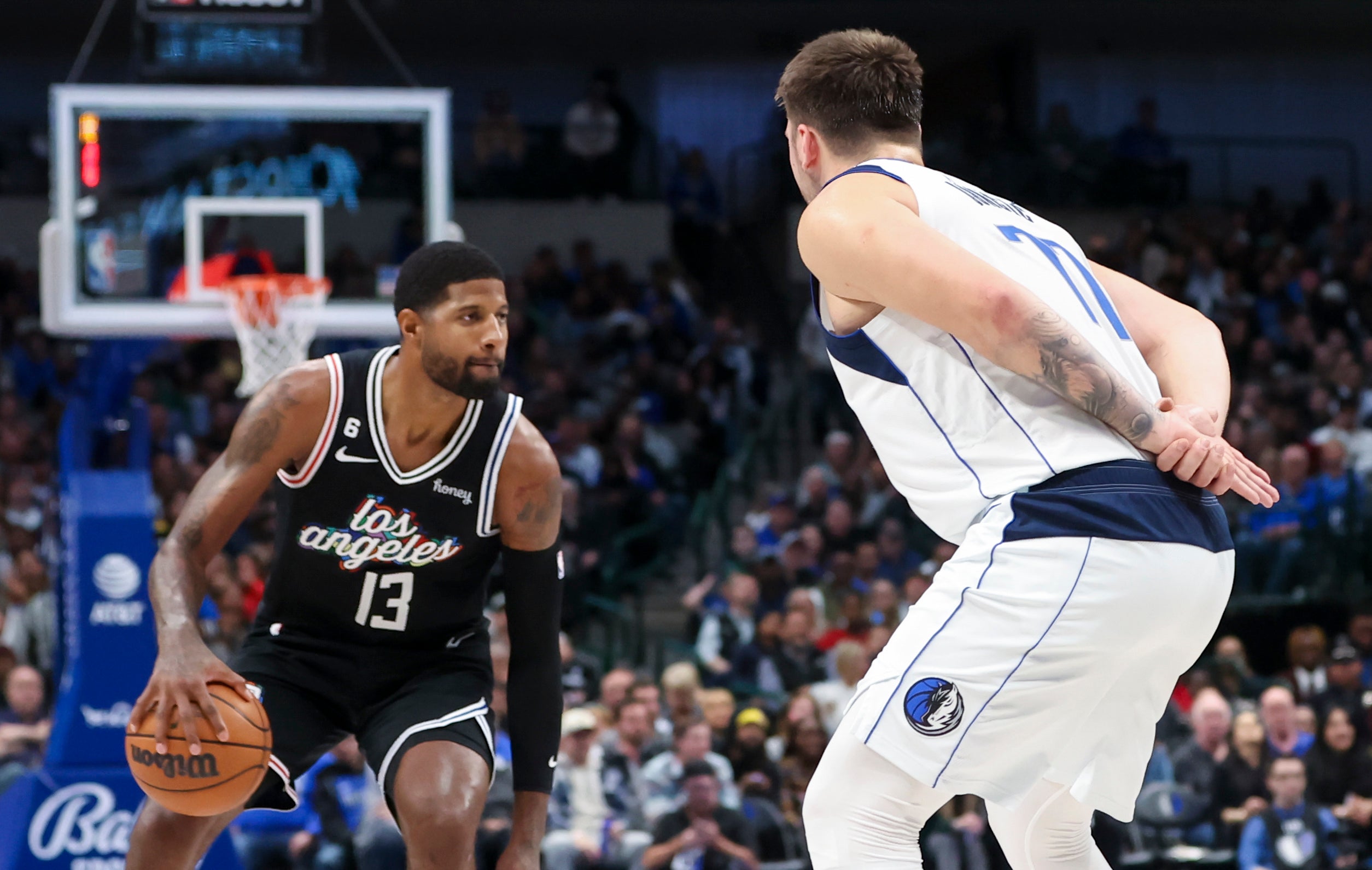 Nov 15, 2022; Dallas, Texas, USA; Dallas Mavericks guard Luka Doncic (77) guards LA Clippers guard Paul George (13) with his hands behind his back during the fourth quarter at American Airlines Center.