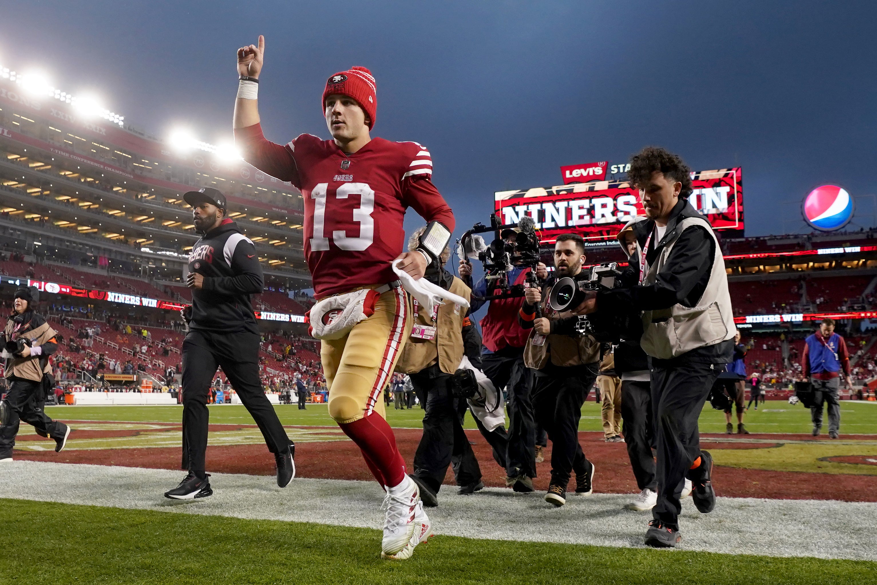 Jan 14, 2023; Santa Clara, California, USA; San Francisco 49ers quarterback Brock Purdy (13) gestures as he runs off the field after defeating the Seattle Seahawks in a wild card game at Levi's Stadium.
