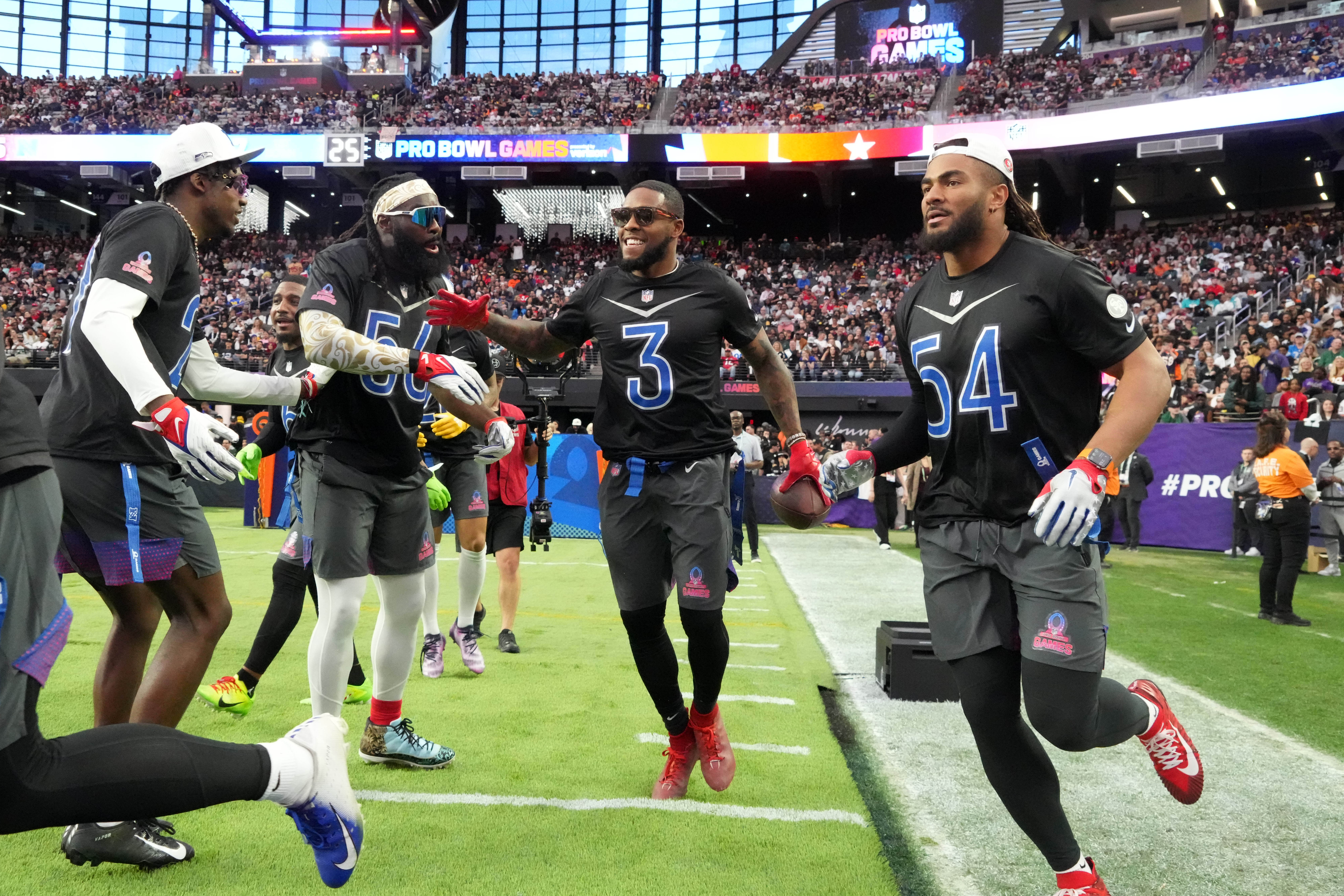 Feb 5, 2023; Paradise, Nevada, USA; NFC safety Budda Baker of the Arizona Cardinals (3) celebrates with cornerback Tariq Woolen of the Seattle Seahawks (27), linebacker Demario Davis of the New Orleans Saints (56), and linebacker Fred Warner of the San Francisco 49ers (54) after intercepting a pass against the AFC during the Pro Bowl Games at Allegiant Stadium. Mandatory Credit: Kirby Lee-USA TODAY Sports