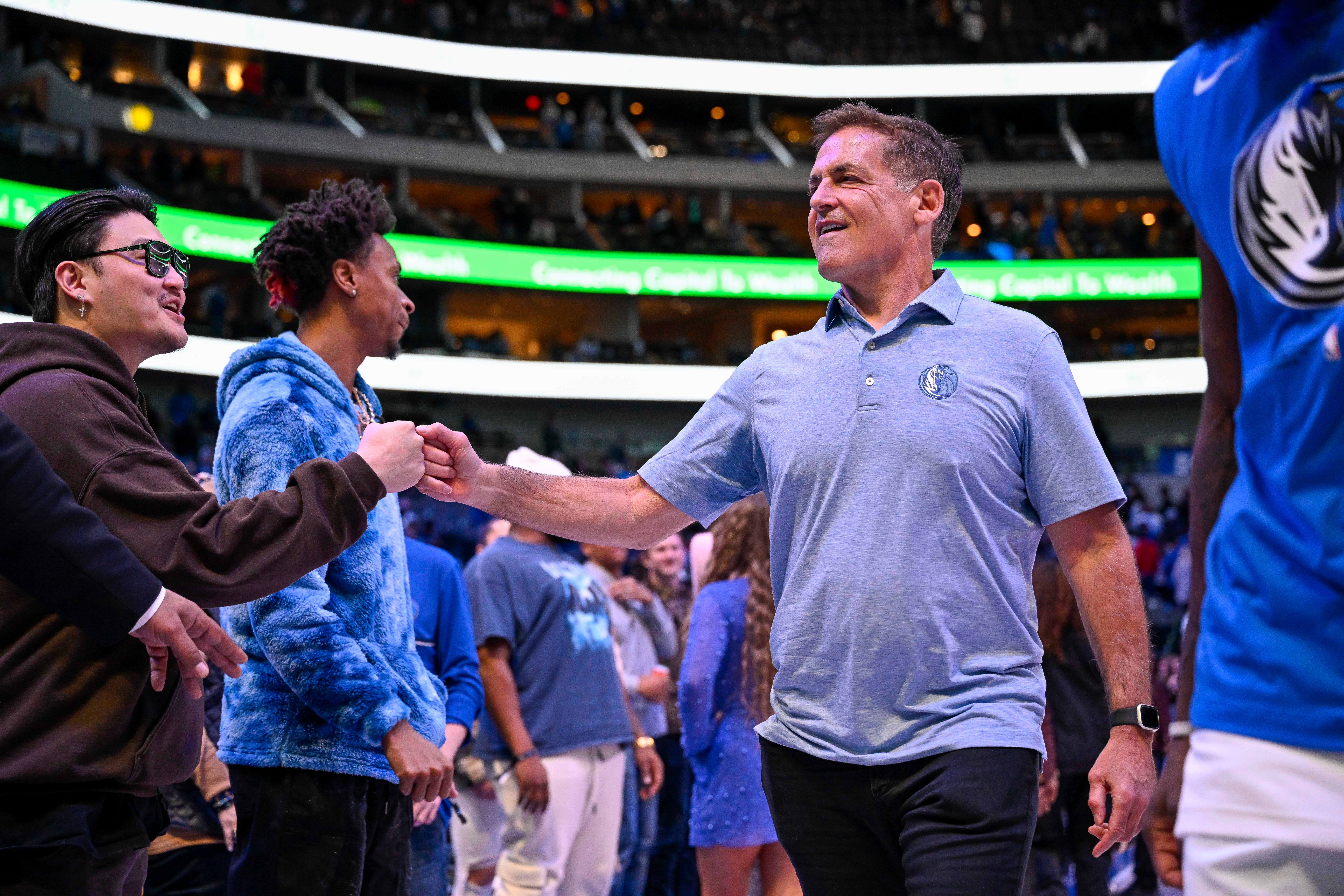 Jan 7, 2023; Dallas, Texas, USA; Dallas Mavericks owner Mark Cuban gives a fist bump to a fan as he walks off the court after the Mavericks defeat the New Orleans Pelicans at the American Airlines Center.