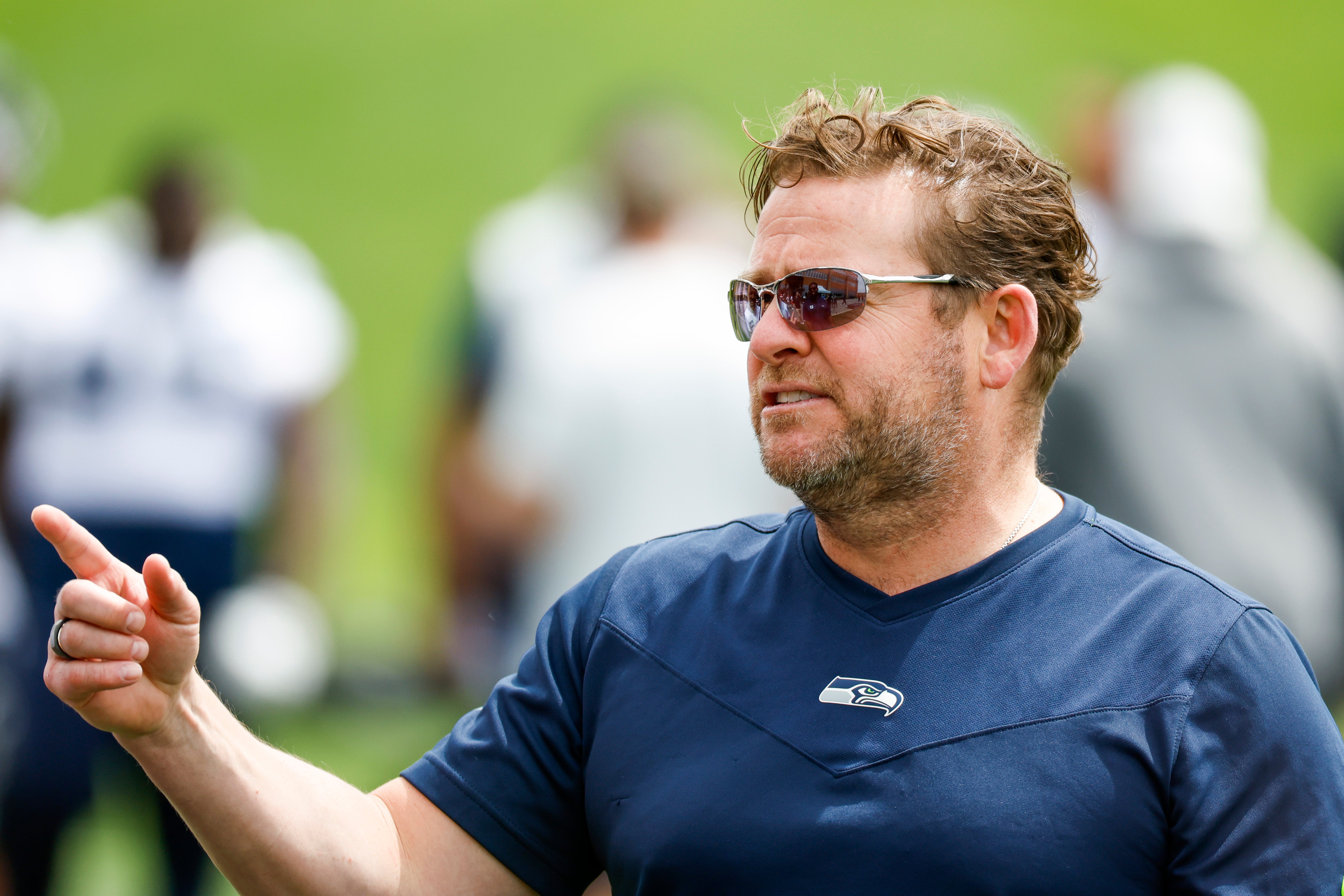 Jun 7, 2022; Renton, Washington, USA; Seattle Seahawks general manager John Schneider talks with a player during minicamp practice at the Virginia Mason Athletic Center Field.