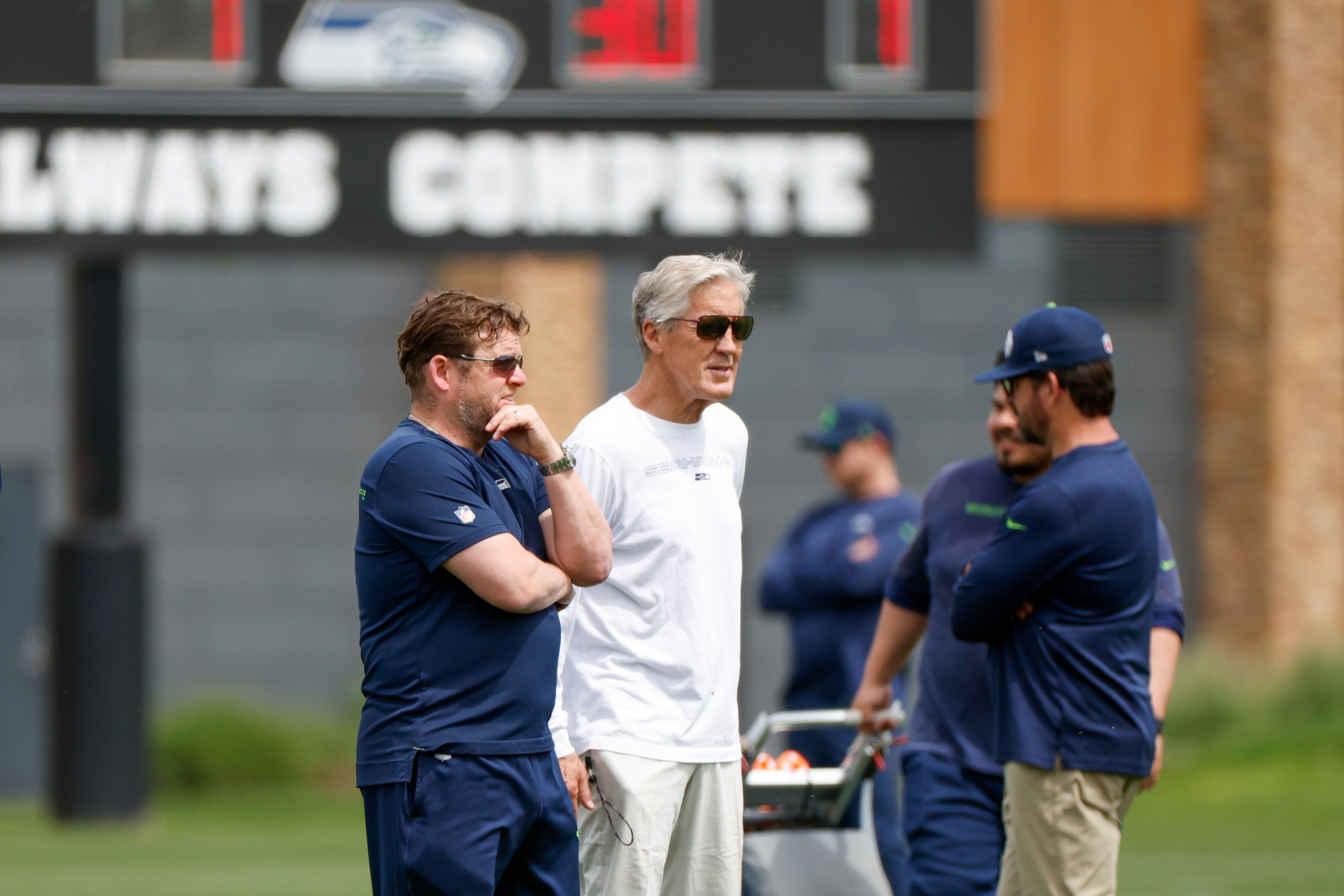 Jun 7, 2022; Renton, Washington, USA; Seattle Seahawks general manager John Schneider (left) and head coach Pete Carroll (right) watch minicamp practice at the Virginia Mason Athletic Center.