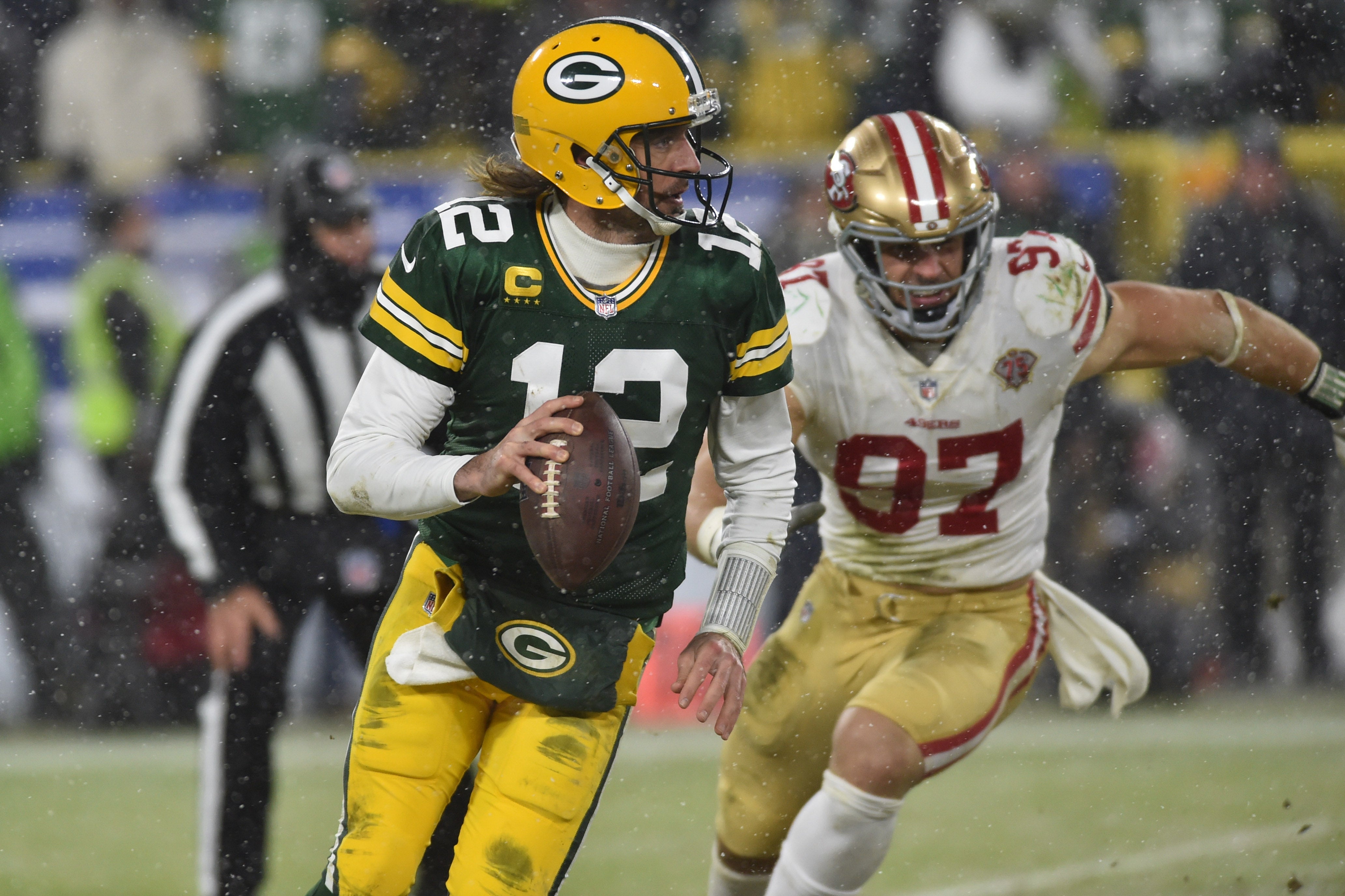 Jan 22, 2022; Green Bay, Wisconsin, USA; Green Bay Packers quarterback Aaron Rodgers (12) and San Francisco 49ers defensive end Nick Bosa (97) in action during a NFC Divisional playoff football game at Lambeau Field.
