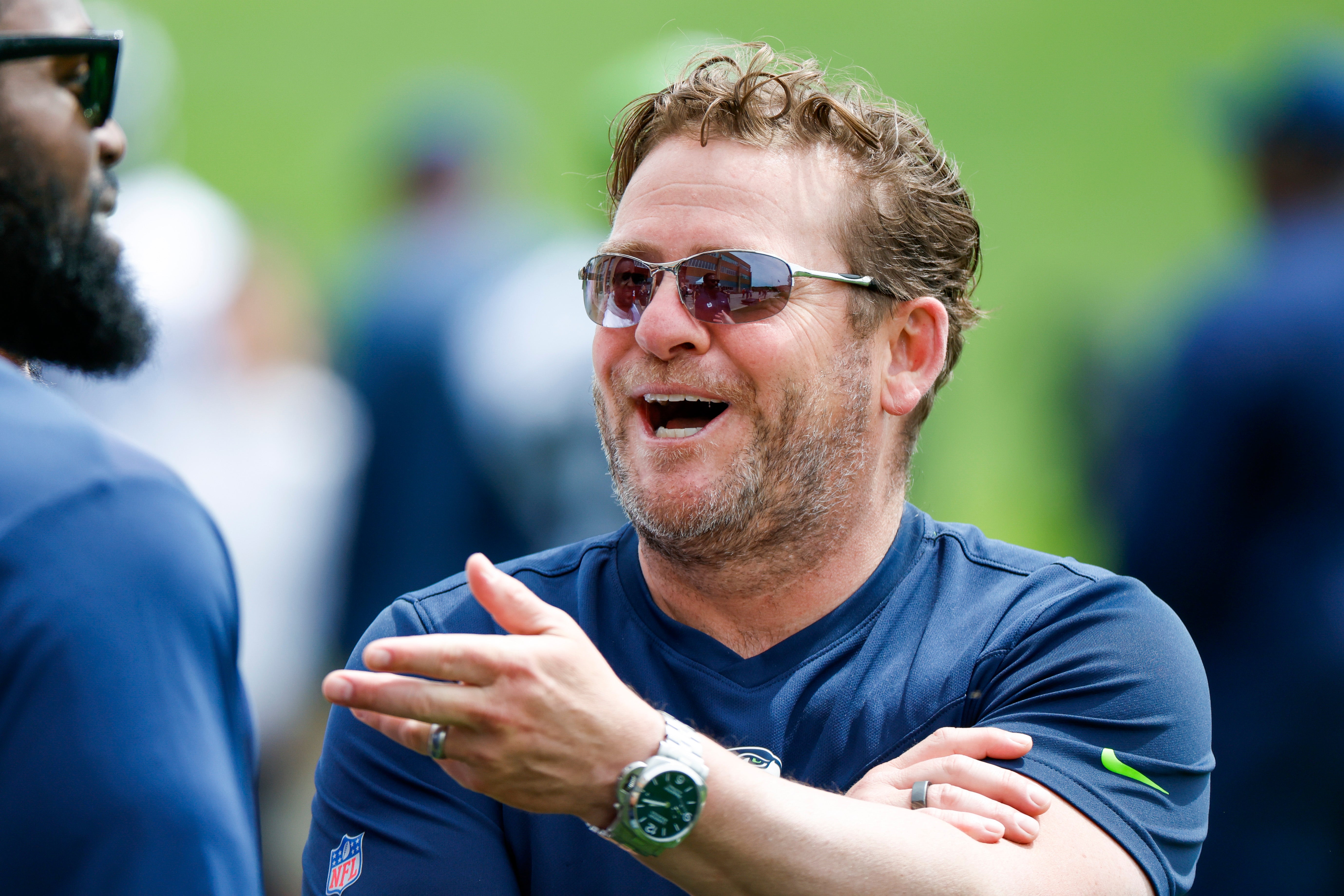 Jun 7, 2022; Renton, Washington, USA; Seattle Seahawks general manager John Schneider talks with a former player during minicamp practice at the Virginia Mason Athletic Center