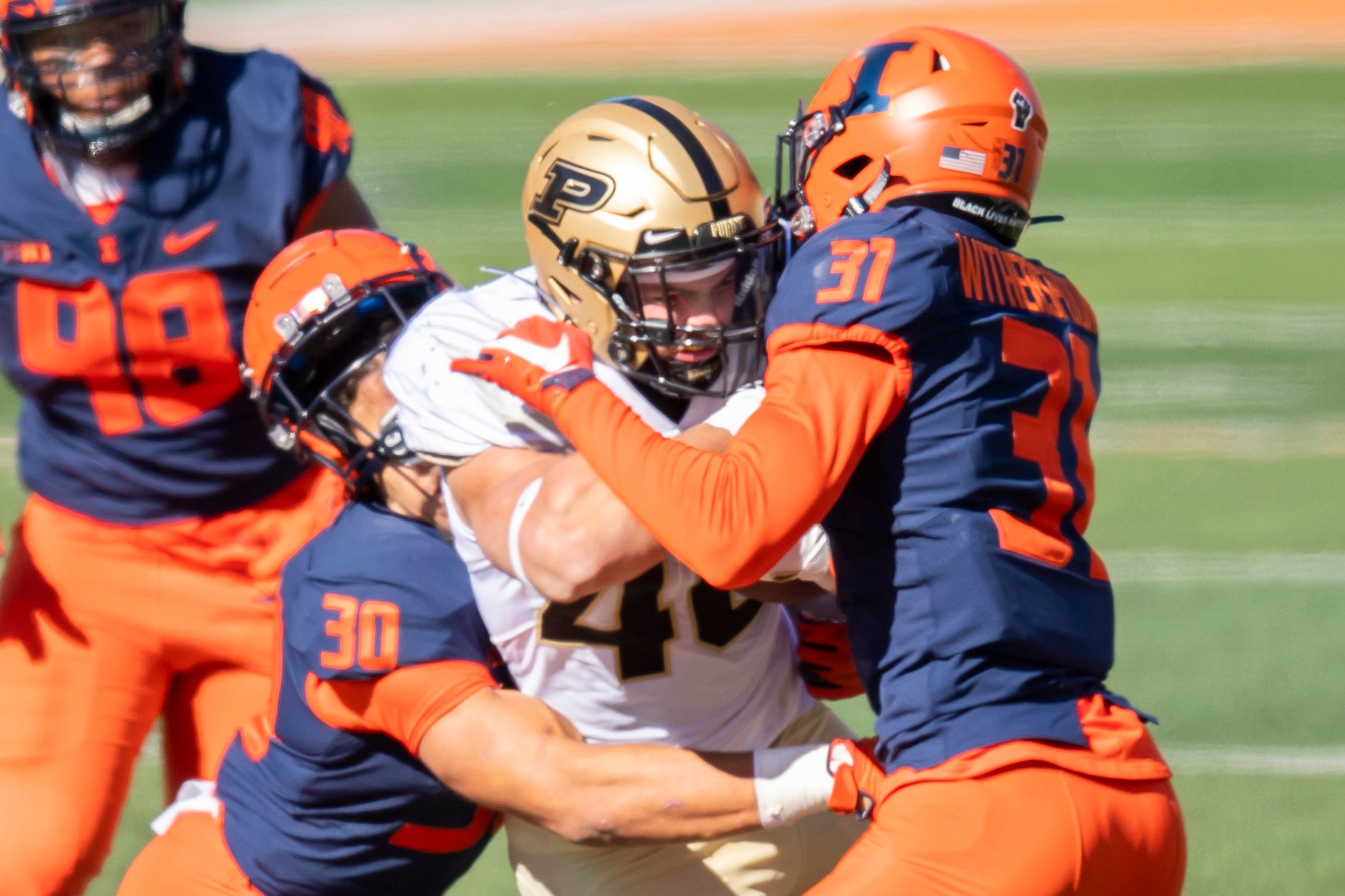 Oct 31, 2020; Champaign, Illinois, USA; Illinois Fighting Illini defensive back Sydney Brown (left) and defensive back Devon Witherspoon (right) tackle Purdue Boilermakers running back Zander Horvath (center) during the first half at Memorial Stadium.