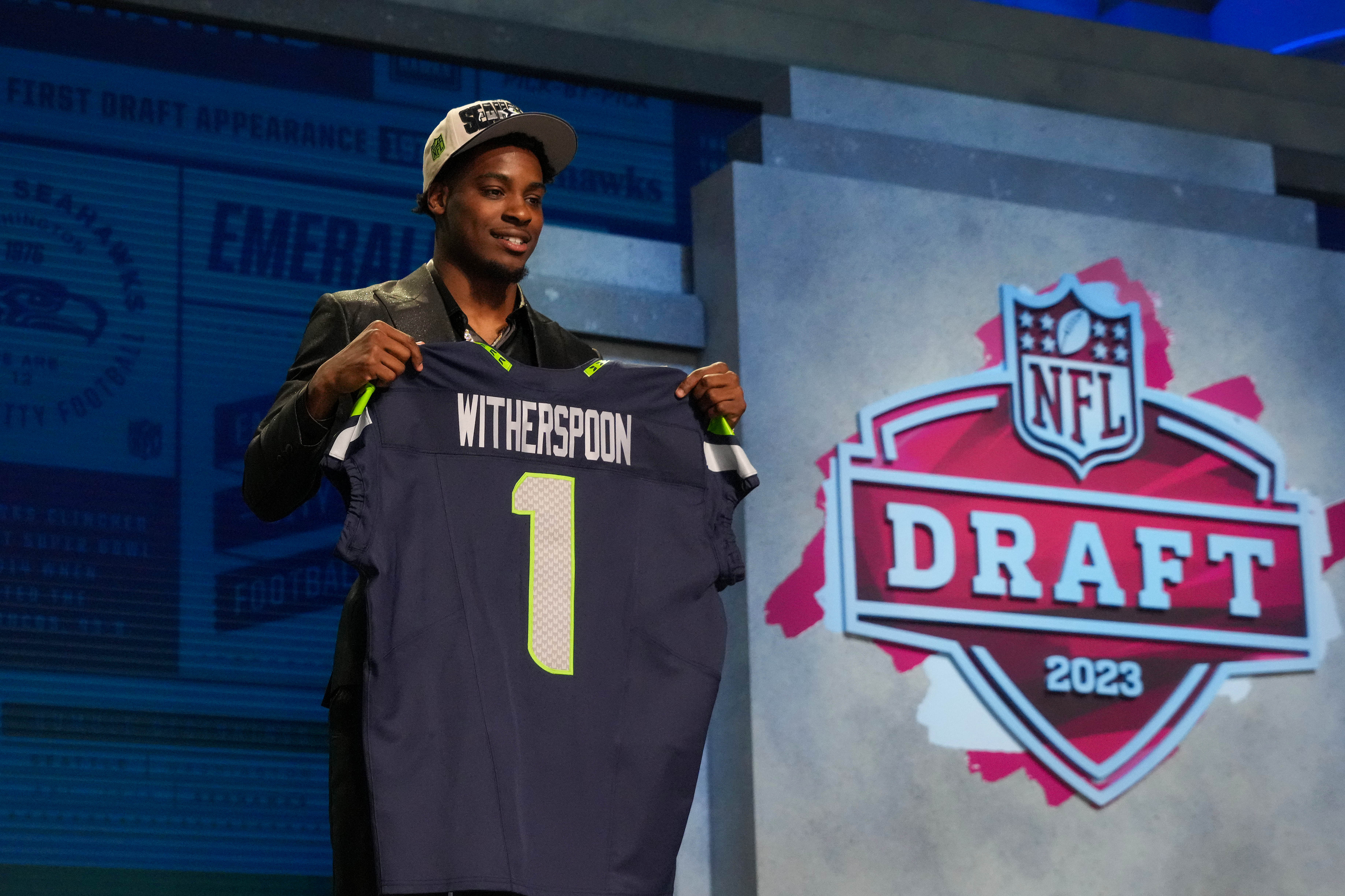 Apr 27, 2023; Kansas City, MO, USA; Illinois cornerback Devon Witherspoon on stage after being selected by the Seattle Seahawks fifth overall in the first round of the 2023 NFL Draft at Union Station.