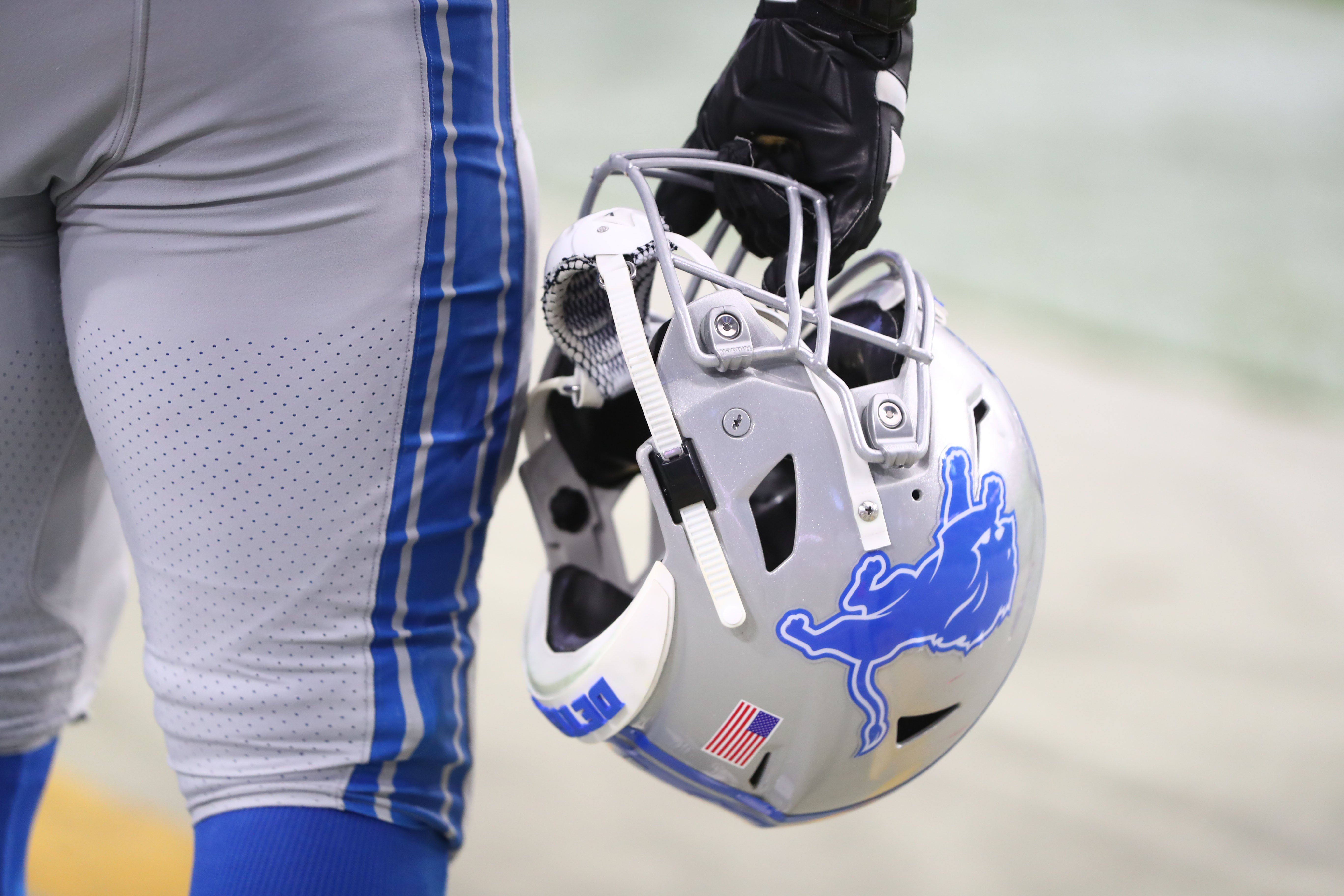 Sep 8, 2019; Glendale, AZ, USA; Detailed view of a Detroit Lions football helmet in the hand of a player on the sidelines against the Arizona Cardinals at State Farm Stadium. Mandatory Credit: Mark J. Rebilas-USA TODAY Sports