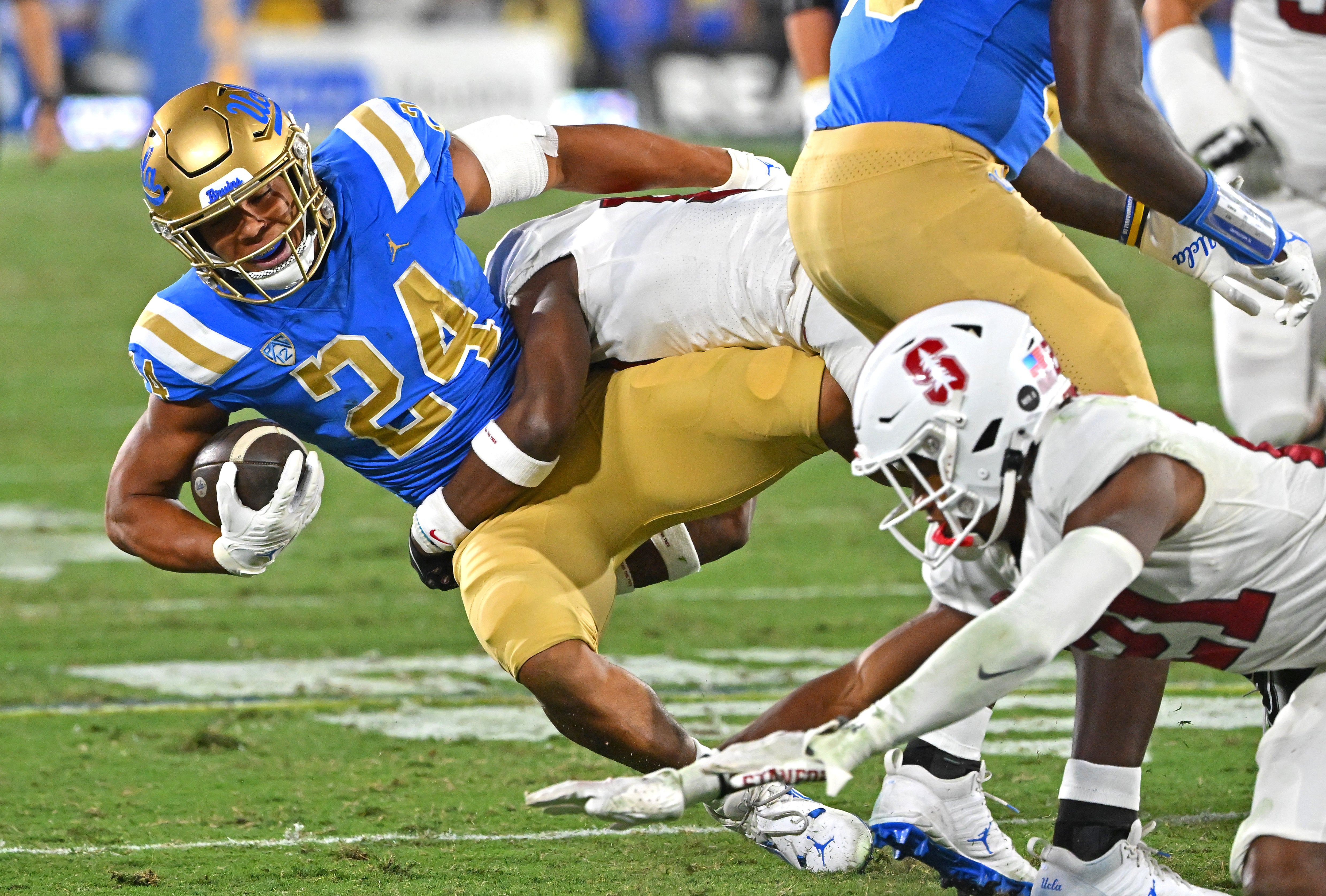 Oct 29, 2022; Pasadena, California, USA; UCLA Bruins running back Zach Charbonnet (24) is taken down by Stanford Cardinal cornerback Kyu Blu Kelly (17) after picking up a first down in the first half at the Rose Bowl.