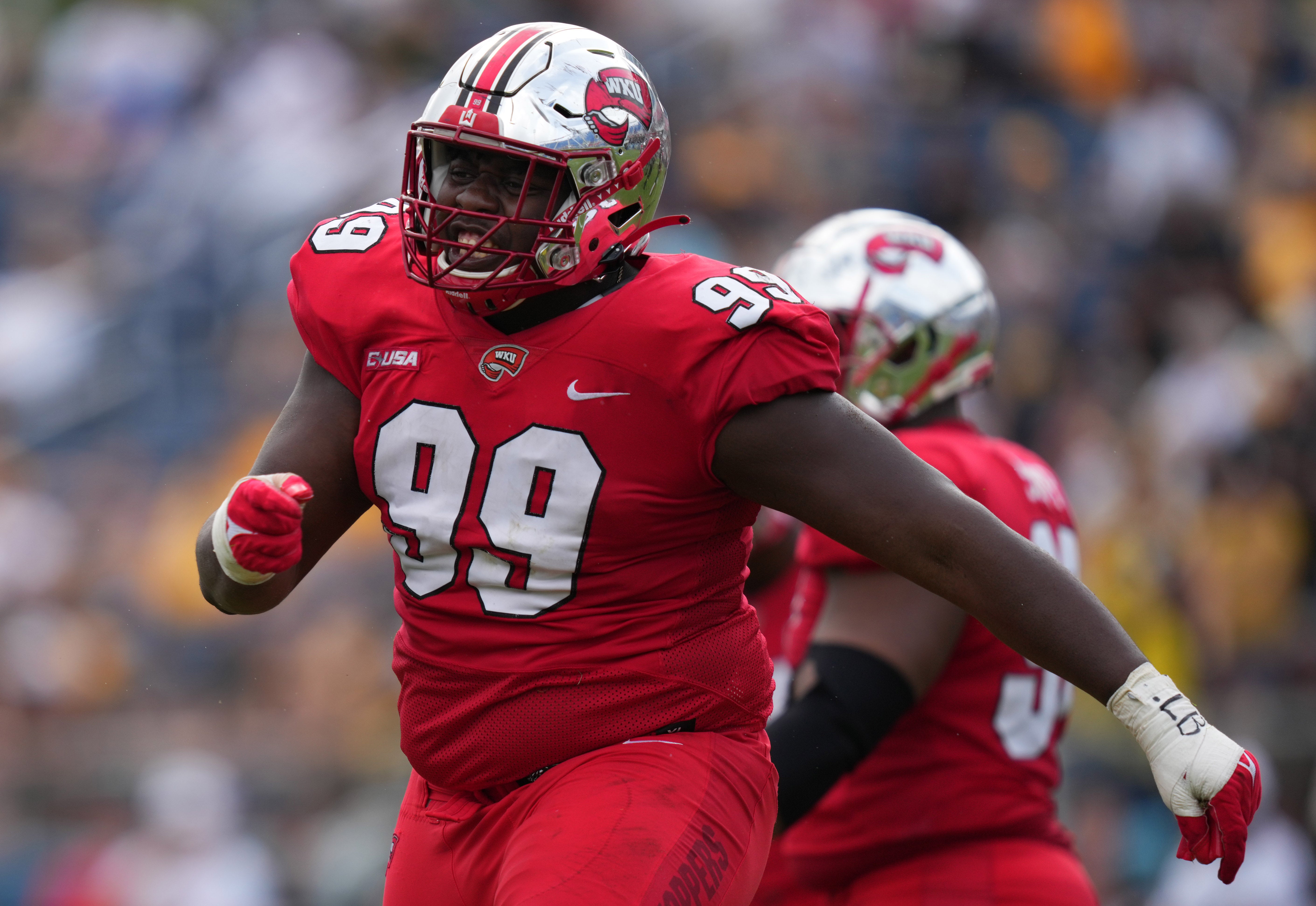 Dec 18, 2021; Boca Raton, Florida, USA; Western Kentucky Hilltoppers defensive tackle Brodric Martin (99) celebrates after making a tackle against the Appalachian State Mountaineers during the second half in the 2021 Boca Raton Bowl at FAU Stadium. Mandatory Credit: Jasen Vinlove-USA TODAY Sports