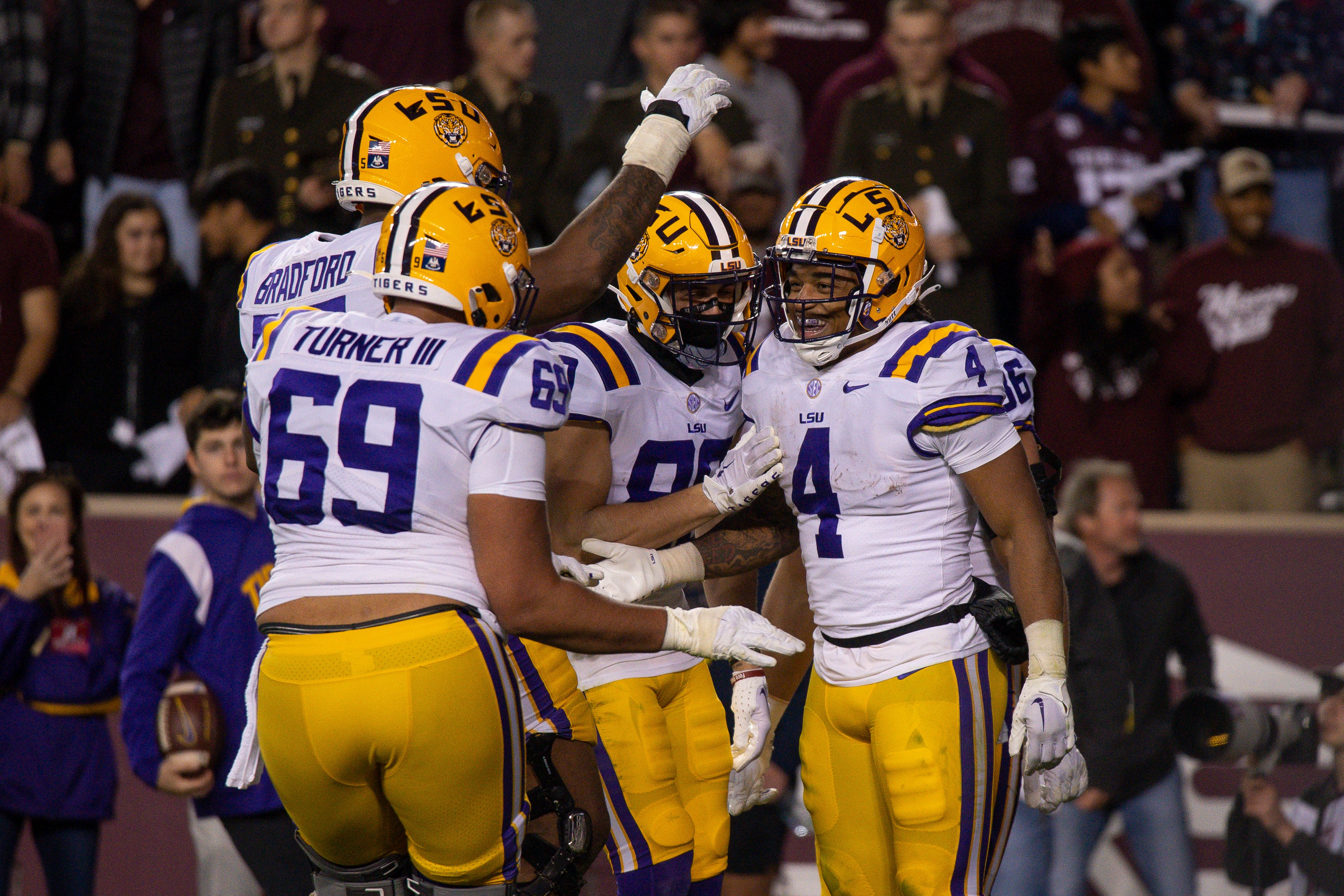 Nov 26, 2022; College Station, Texas, USA; LSU Tigers offensive lineman Anthony Bradford (75) and offensive lineman Charles Turner (69) and running back John Emery Jr. (4) celebrates a touchdown against the Texas A&M Aggies during the second half at Kyle Field.