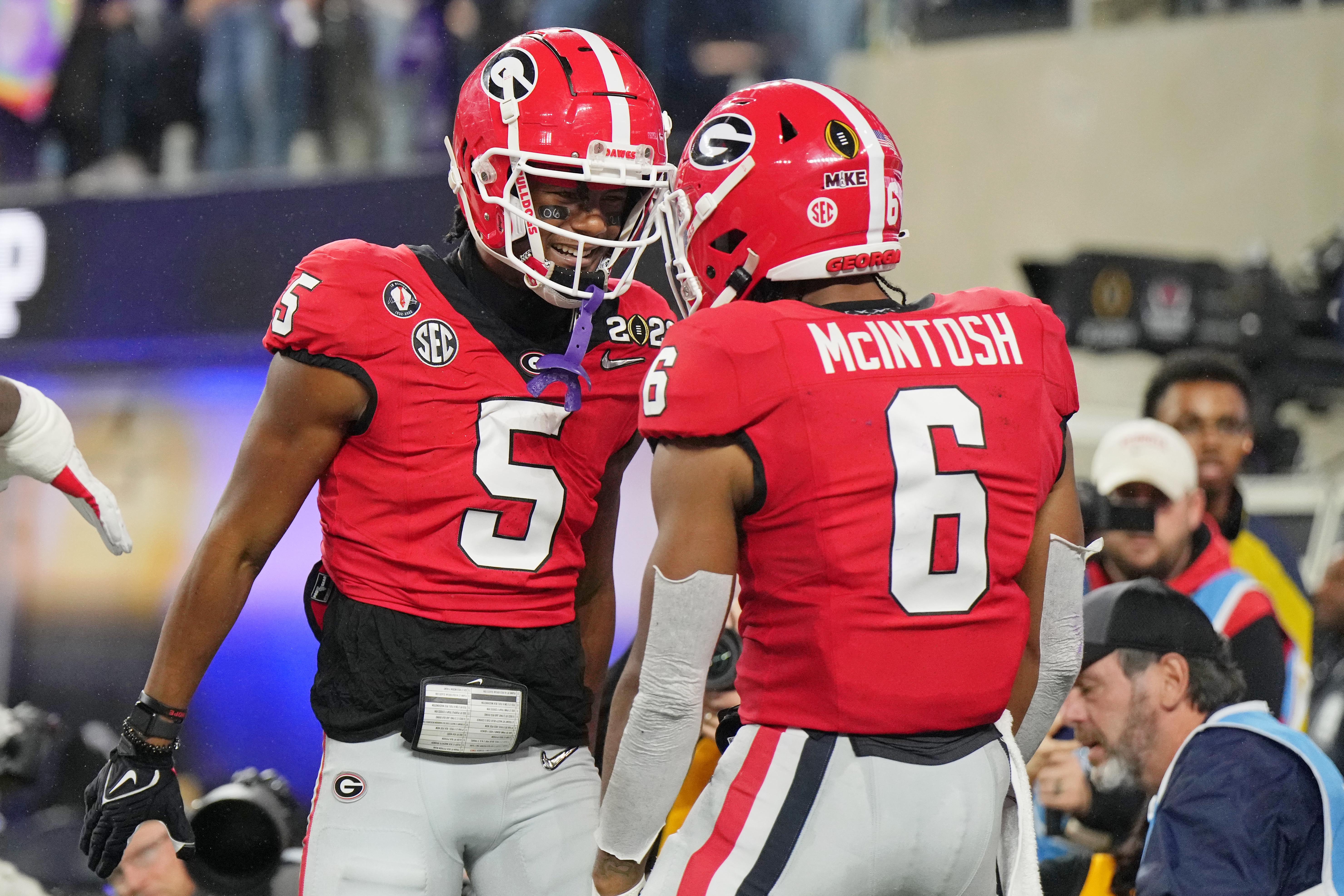 Jan 9, 2023; Inglewood, CA, USA; Georgia Bulldogs wide receiver Adonai Mitchell (5) celebrates with running back Kenny McIntosh (6) after making a catch for a touchdown against the TCU Horned Frogs during the second quarter of the CFP national championship game at SoFi Stadium.