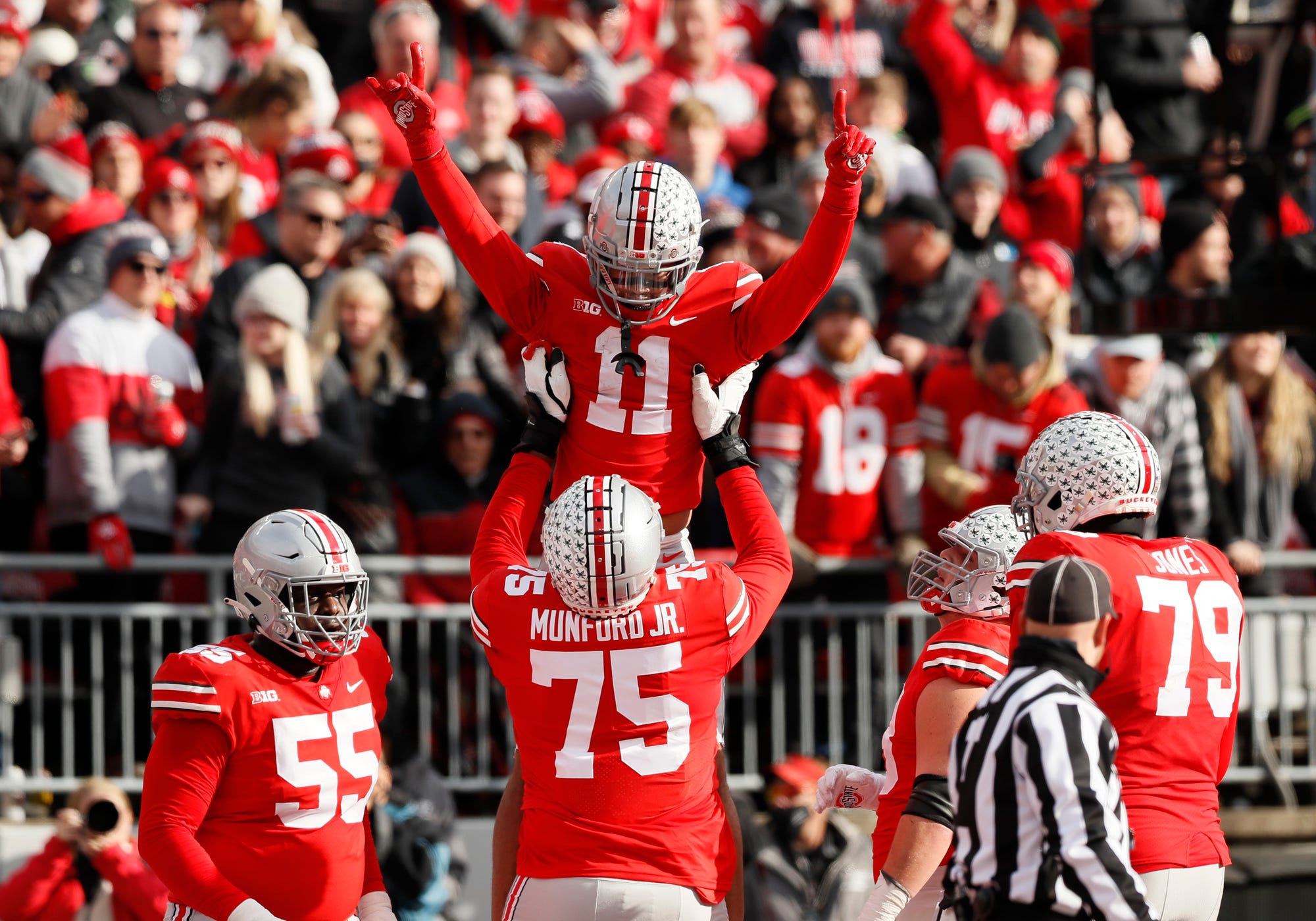 Ohio State Buckeyes wide receiver Jaxon Smith-Njigba (11) celebrates scoring a touchdown with offensive lineman Thayer Munford (75) during the second quarter of the NCAA football game against the Michigan State Spartans at Ohio Stadium in Columbus on Saturday, Nov. 20, 2021.