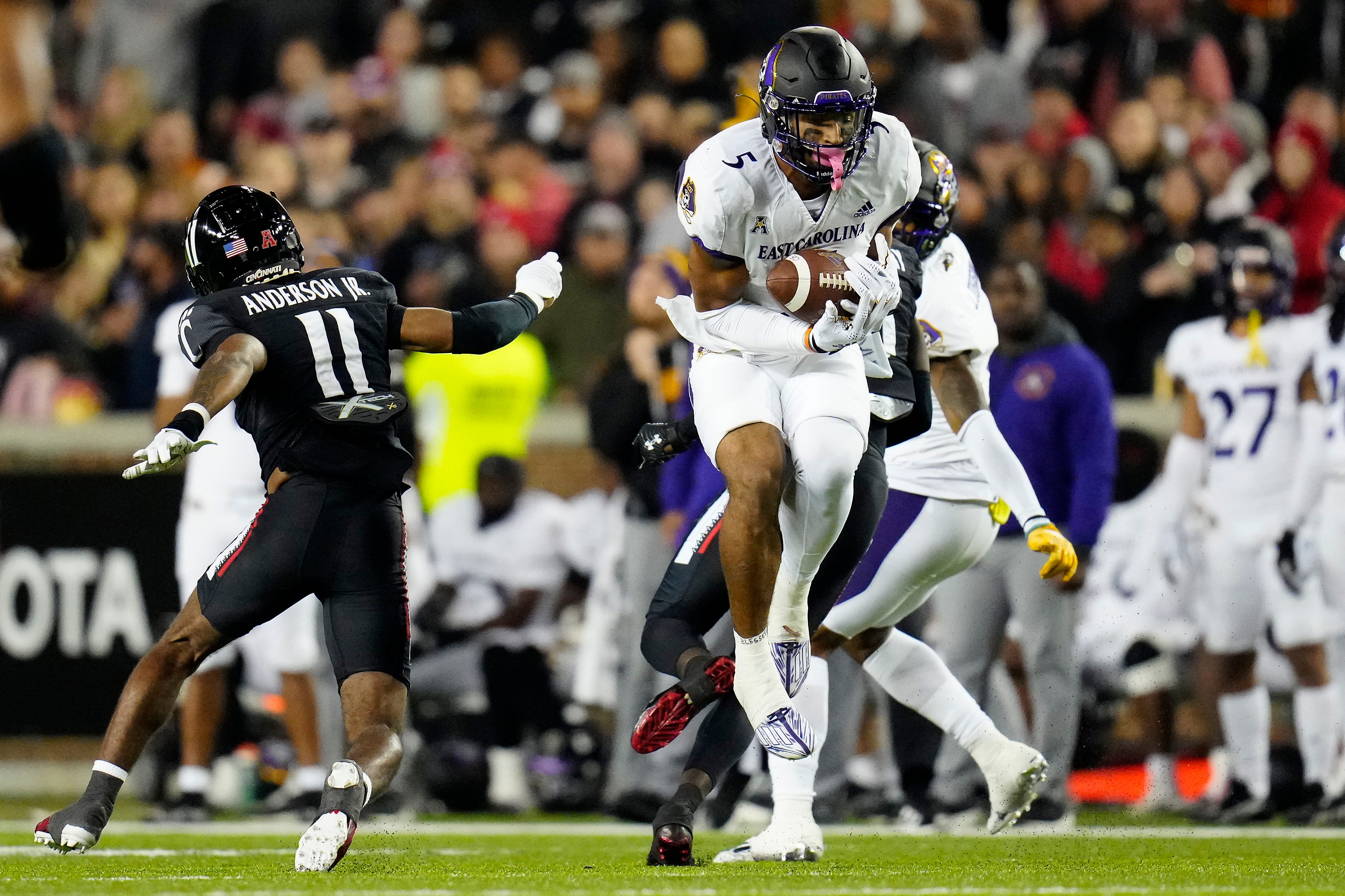 East Carolina Pirates wide receiver C.J. Johnson (5) catches a pass in the second quarter of the NCAA American Athletic Conference game between the Cincinnati Bearcats and the East Carolina Pirates at Nippert Stadium in Cincinnati on Friday, Nov. 11, 2022. East Carolina Pirates At Cincinnati Bearcats Football.