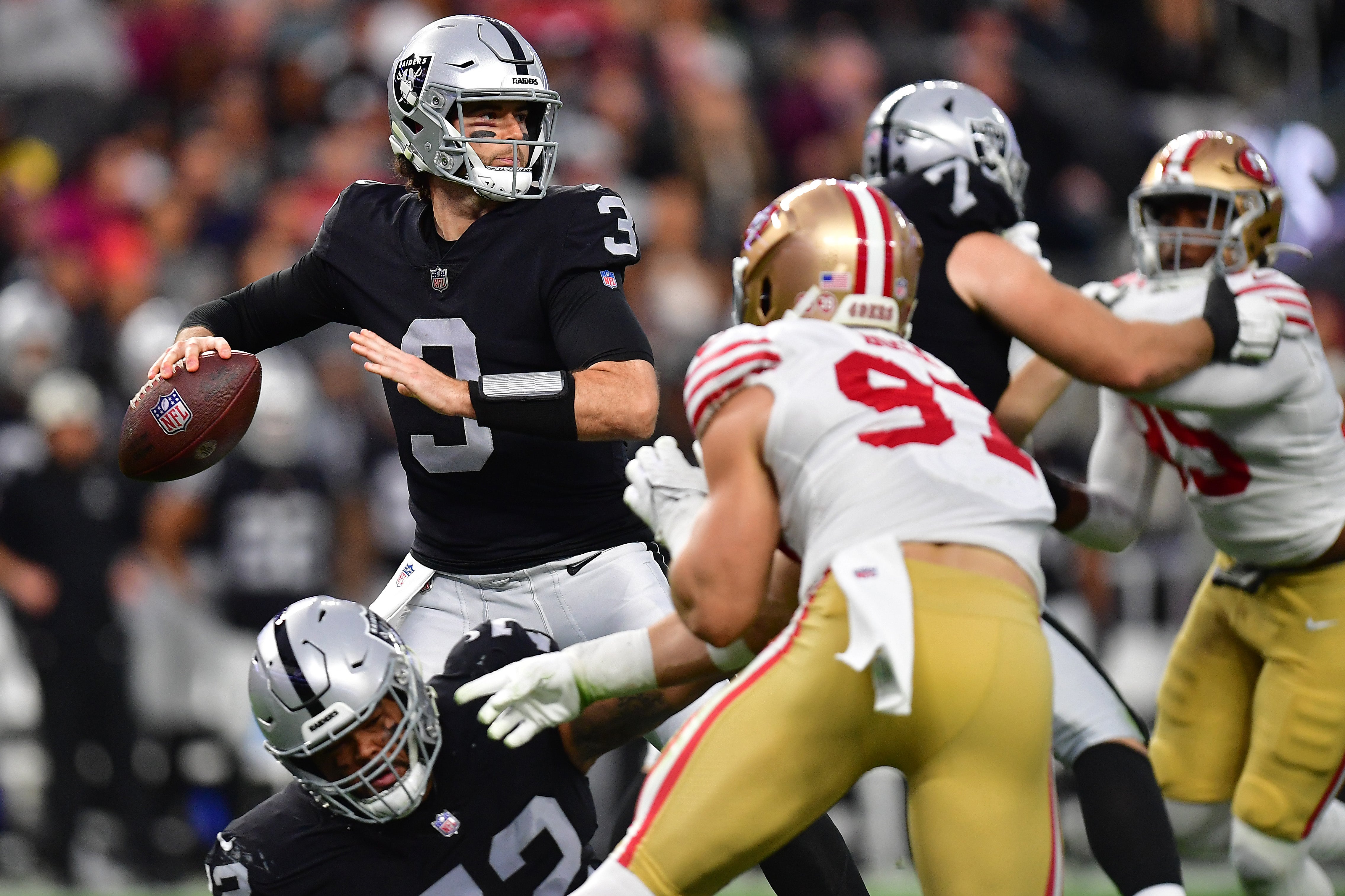 January 1, 2023; Paradise, Nevada, USA; Las Vegas Raiders quarterback Jarrett Stidham (3) throws as San Francisco 49ers defensive end Nick Bosa (97) moves in during the first half at Allegiant Stadium.